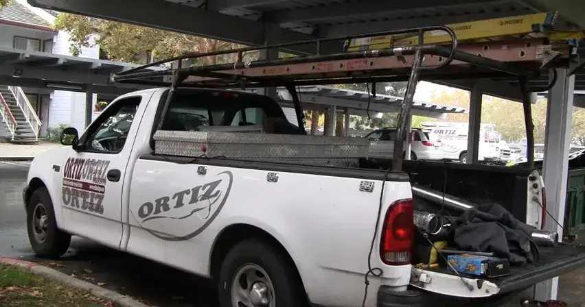 Picture of One of Ortiz Heating and Air Conditioning's service vehicles at a job site - Ortiz Heating and Air Conditioning