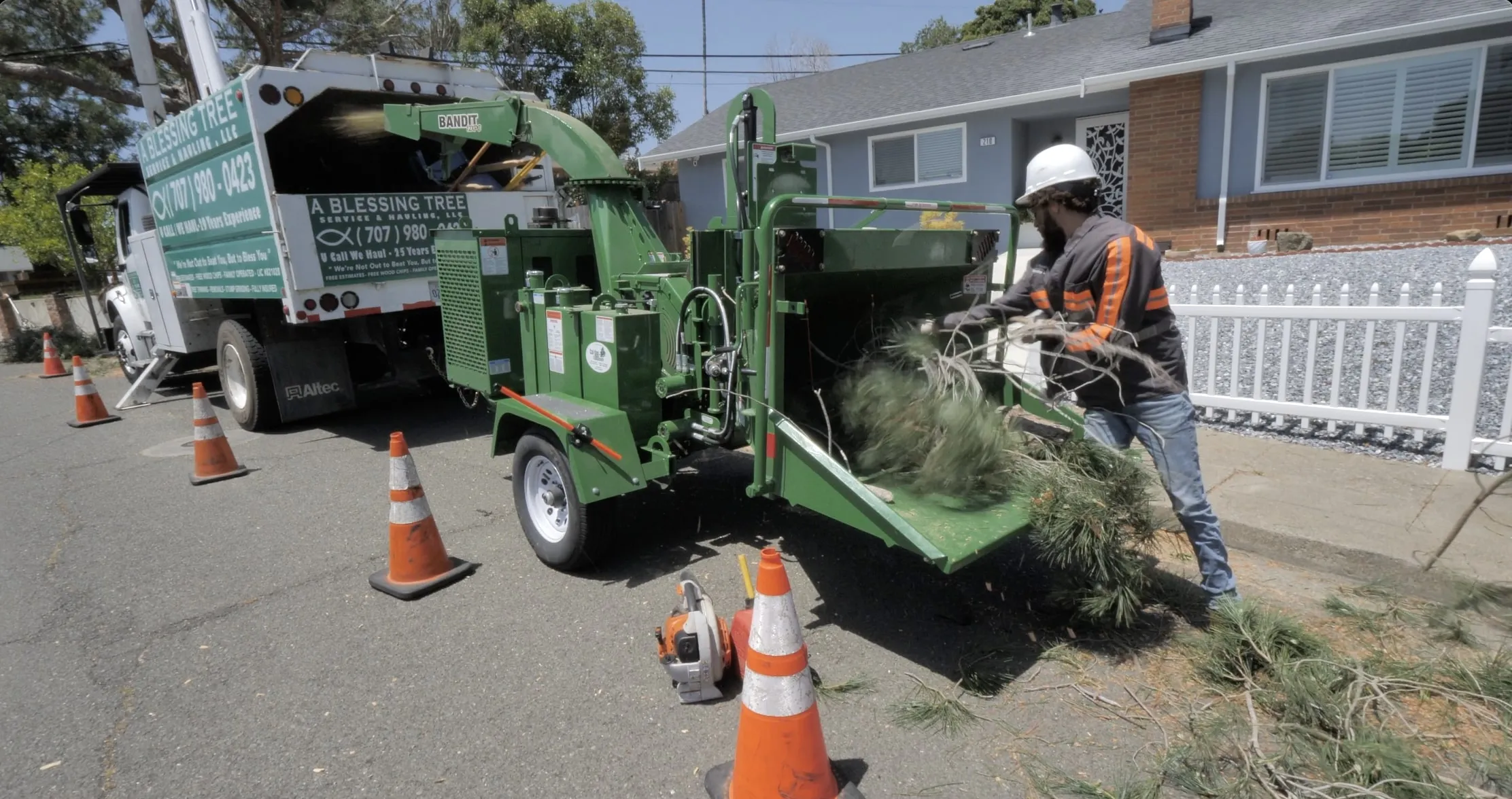 Picture of Amidst the rhythmic hum of machinery, a worker from A Blessing Tree Service expertly feeds branches into the chipper, reflecting the companyâ€™s focus on quality outcomes. Copyright ©2025 Diamond Certified Resource

 - A Blessing Tree Service