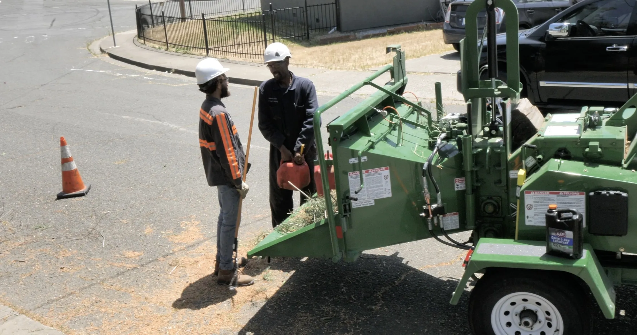 Picture of At a quiet residential street corner, two workers from A Blessing Tree Service prepare equipment, reflecting the company's consistent achievement of a Highest in Quality rating. Their practiced precision underscores a dedication to quality outcomes. Copyright ©2025 Diamond Certified Resource - A Blessing Tree Service