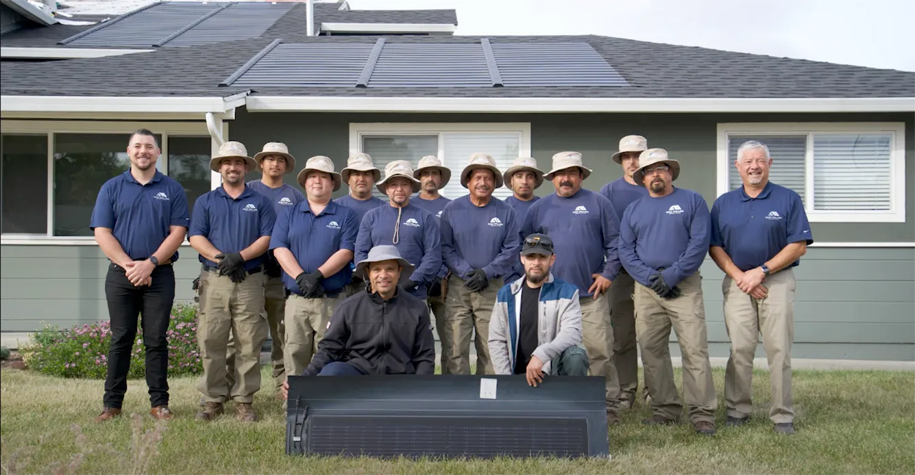 Picture of A dedicated team from Bay Valley Roofing stands unified in front of a newly installed solar panel array, embodying the companyâ€™s focus on quality outcomes and sustainable solutions. Copyright ©2025 Diamond Certified Resource

 - Bay Valley Roofing