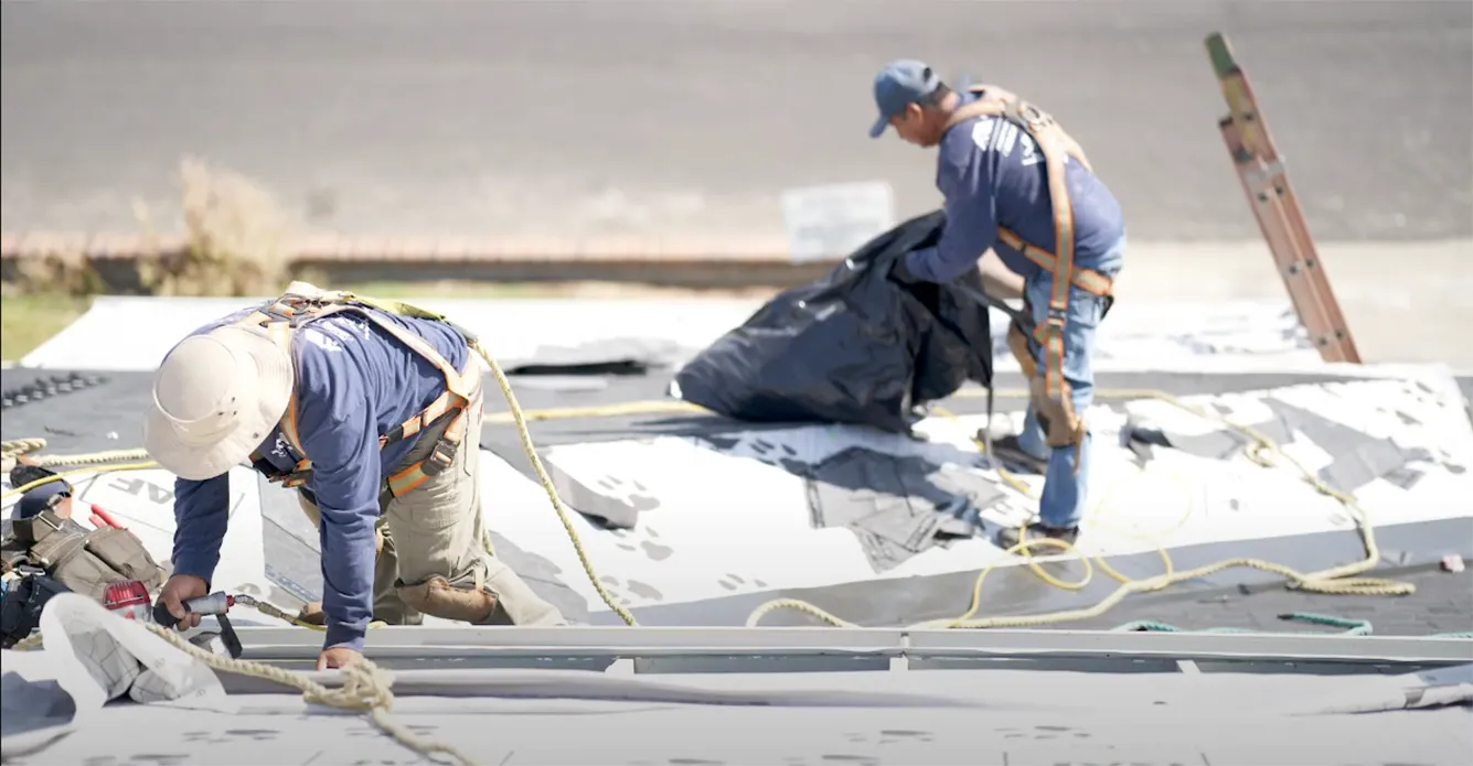 Picture of Two workers meticulously install roofing materials, embodying Bay Valley Roofing's commitment to quality outcomes. Their expertise has earned them the Diamond Certified accolade. Copyright ©2025 Diamond Certified Resource - Bay Valley Roofing