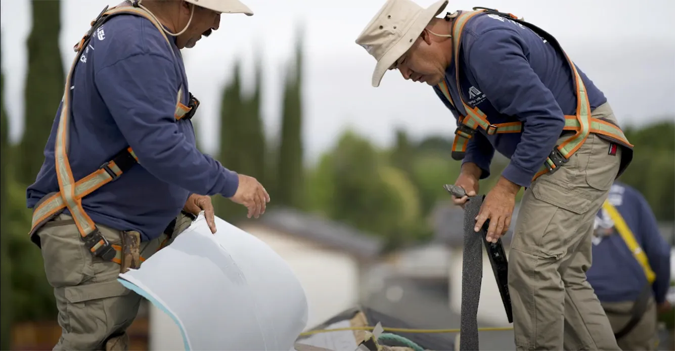 Picture of Two workers focus intently on a roofing task, highlighting Bay Valley Roofing's dedication to quality outcomes. Their precision underscores the company's top-rated expertise. Copyright ©2025 Diamond Certified Resource - Bay Valley Roofing