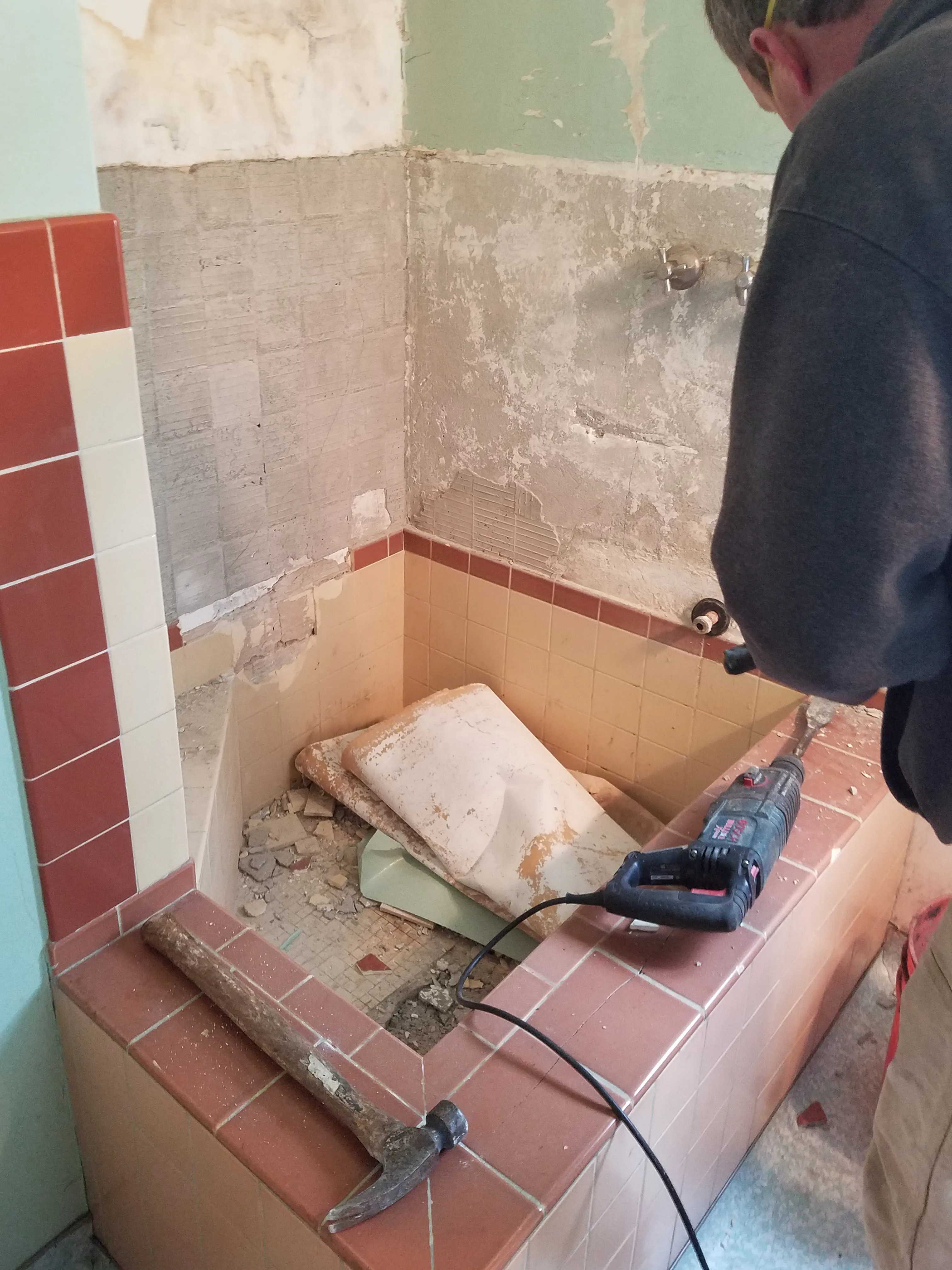 Picture of Amidst the rubble of an old bathroom wall, a worker from Dahme Construction skillfully handles renovation tools, embodying the company's focus on quality outcomes. Copyright ©2025 Diamond Certified Resource

 - Dahme Construction