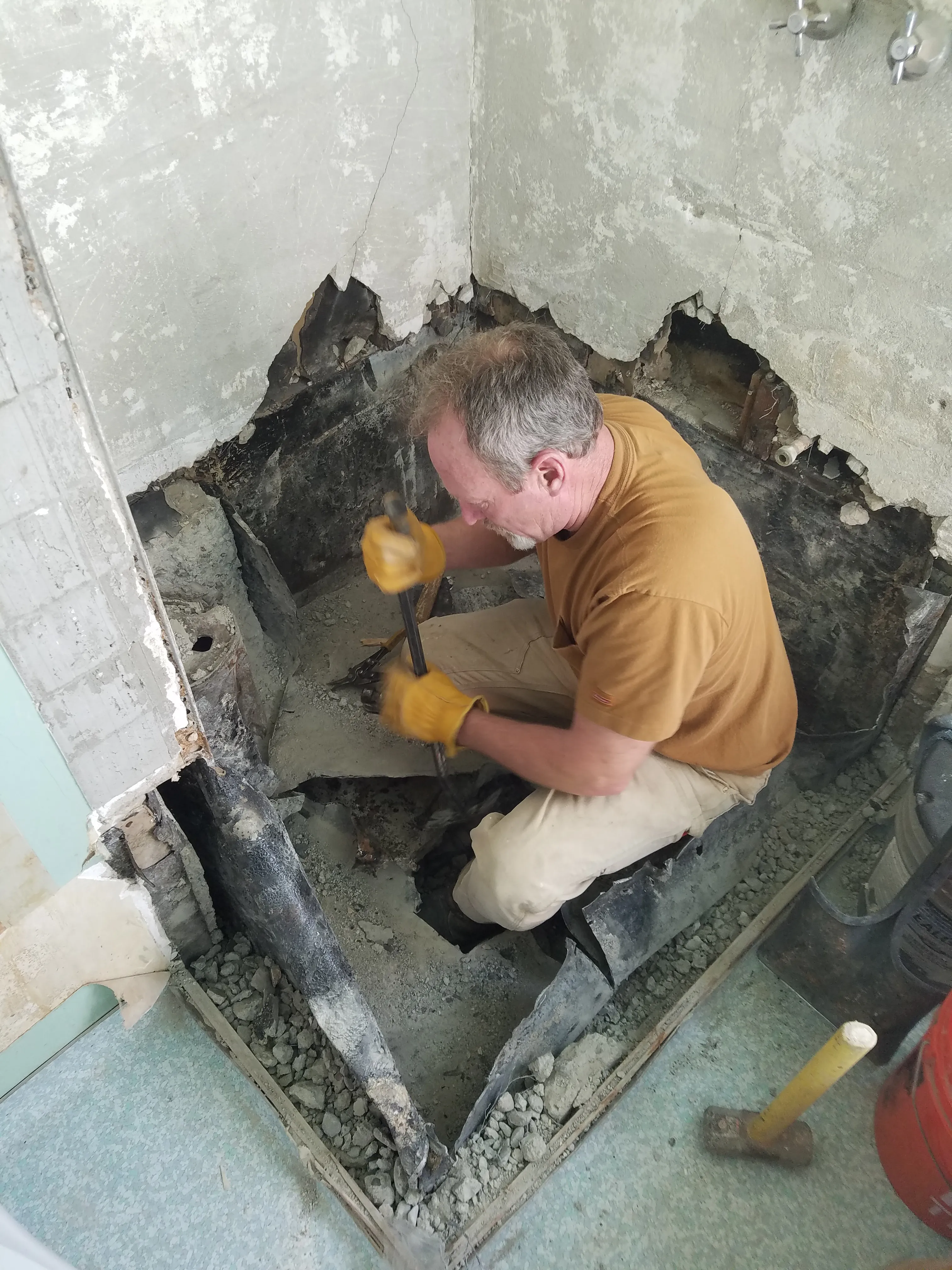 Picture of In a quiet moment on the job, a skilled worker focuses intently on removing old piping to prepare for a transformative renovation. Dahme Construction is recognized for its expertise and quality. Copyright ©2025 Diamond Certified Resource

 - Dahme Construction