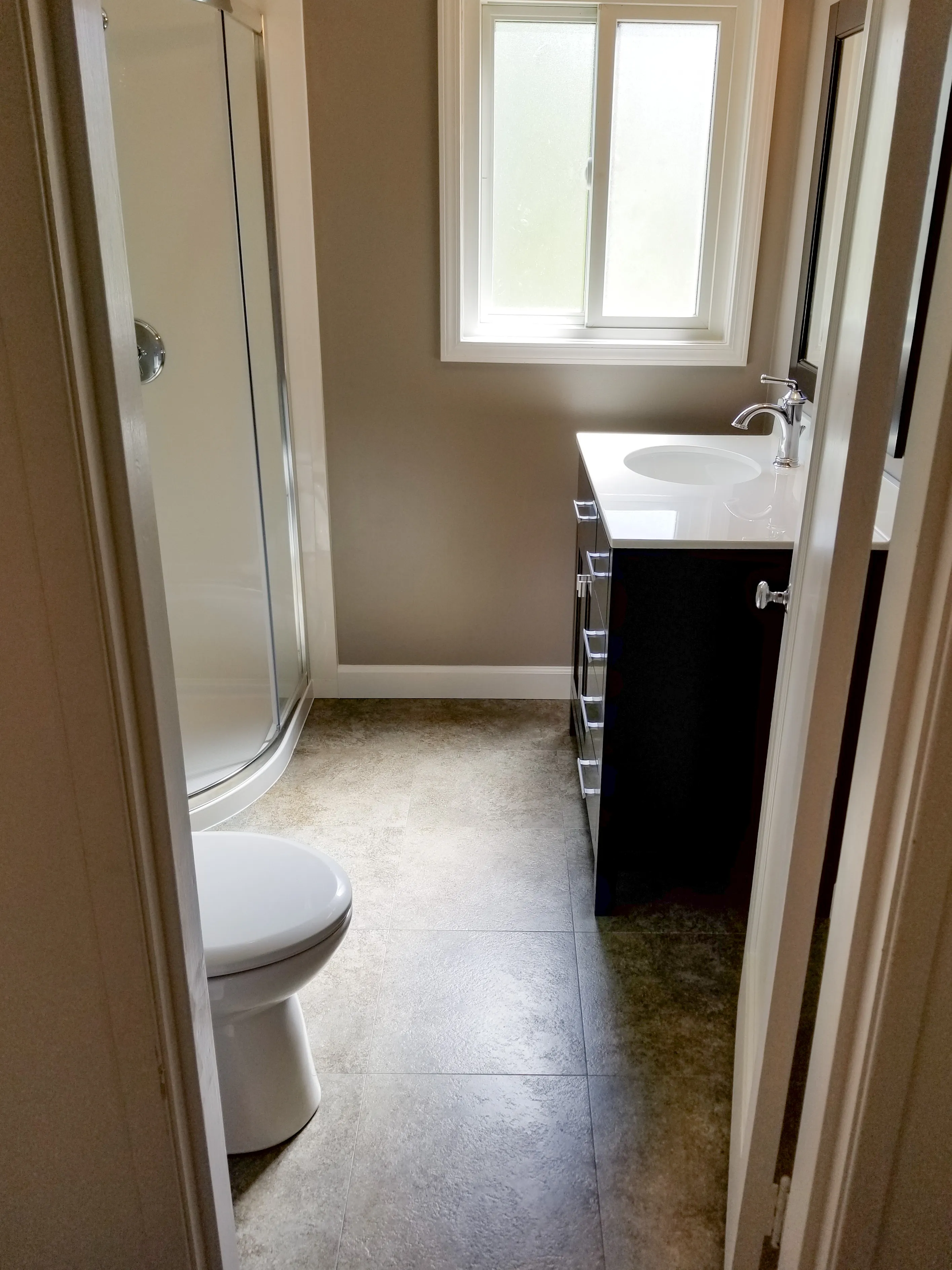 Picture of Sunlight filters through the window, illuminating the pristine finishes of a newly renovated bathroom by Dahme Construction. With clean lines and a modern design, this project highlights the company's focus on quality outcomes. Copyright ©2025 Diamond Certified Resource - Dahme Construction