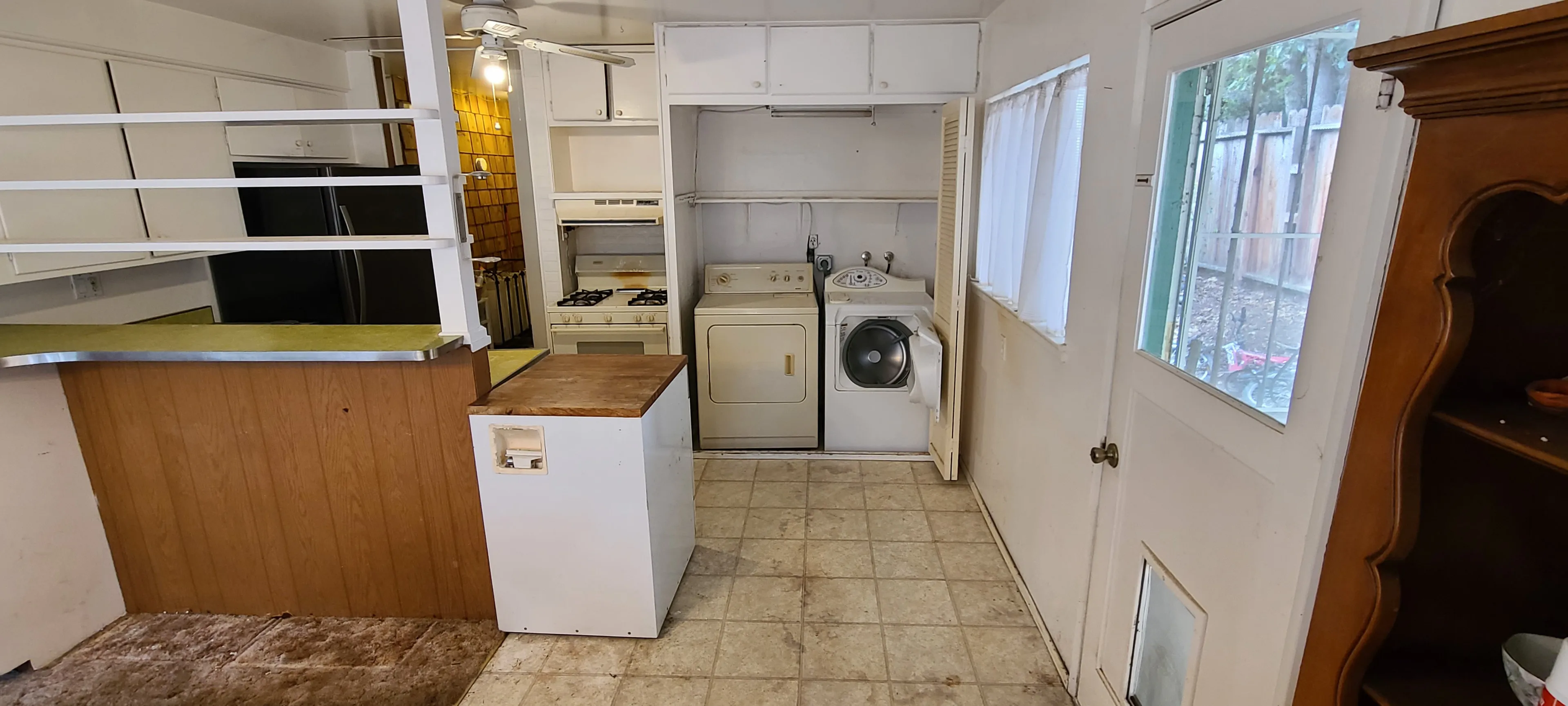 Picture of An intimate peek into a transitional space reveals a laundry area nestled in a cozy kitchen setting. Dahme Construction, known for its high customer satisfaction ratings, is set to transform these dated interiors into a modern masterpiece. Copyright ©2025 Diamond Certified Resource

 - Dahme Construction