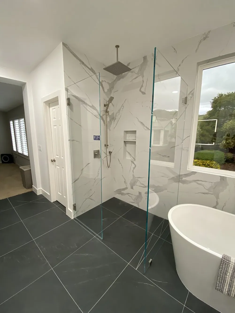 Picture of In a beautifully renovated bathroom, Design Miter Tile showcases its commitment to quality with expertly installed marble tiles and sleek glass shower panels. Known for consistently achieving a Highest in Quality rating, the company transforms spaces with precision and style. Copyright ©2025 Diamond Certified Resource

 - Design Miter Tile