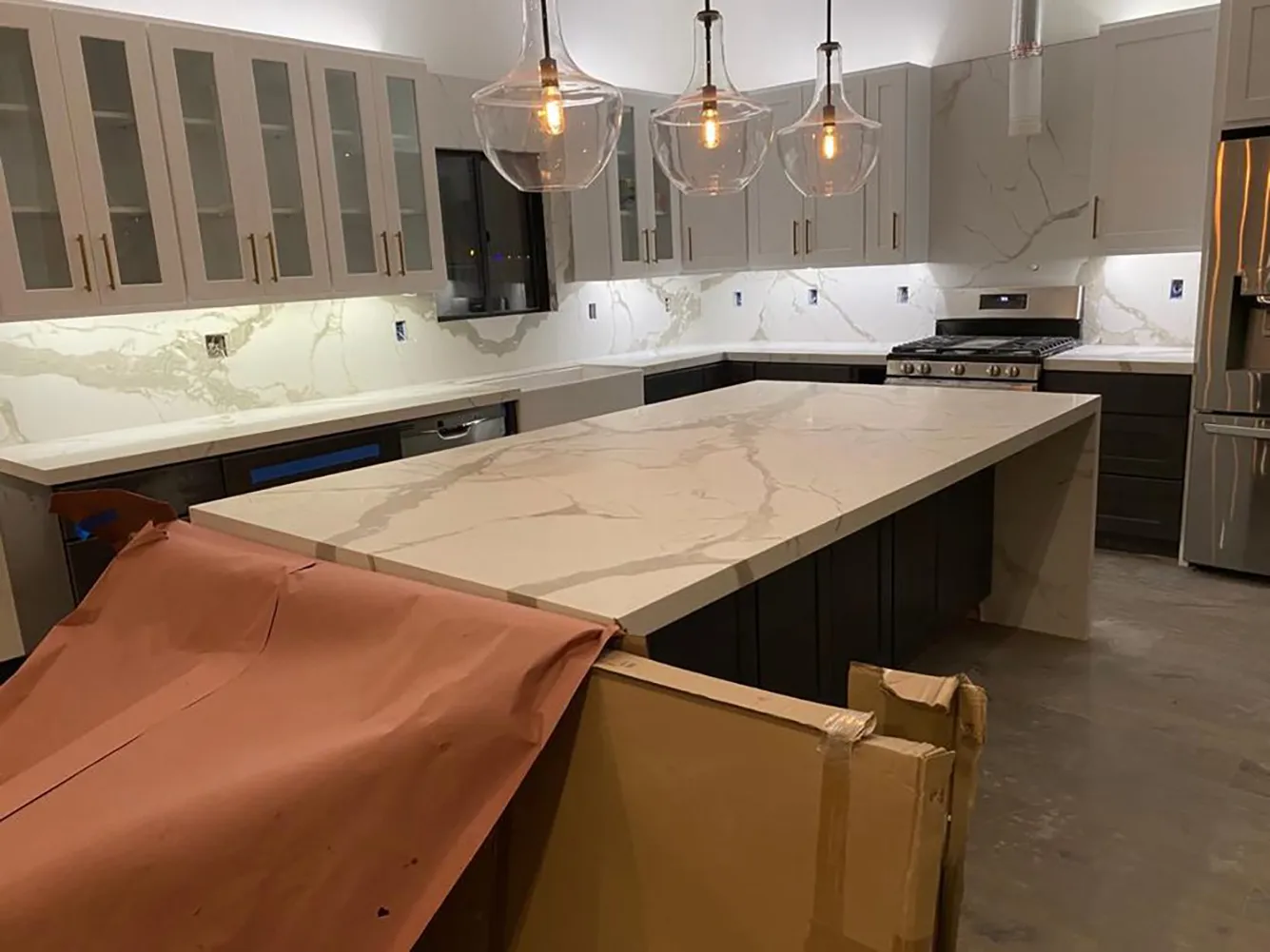 Picture of In a quiet evening glow, a brand-new kitchen awaits its final touches, with a pristine marble-topped island as its centerpiece. Design Miter Tile, known for their high customer satisfaction ratings, has crafted this space with an eye for functional elegance. Copyright ©2025 Diamond Certified Resource

 - Design Miter Tile