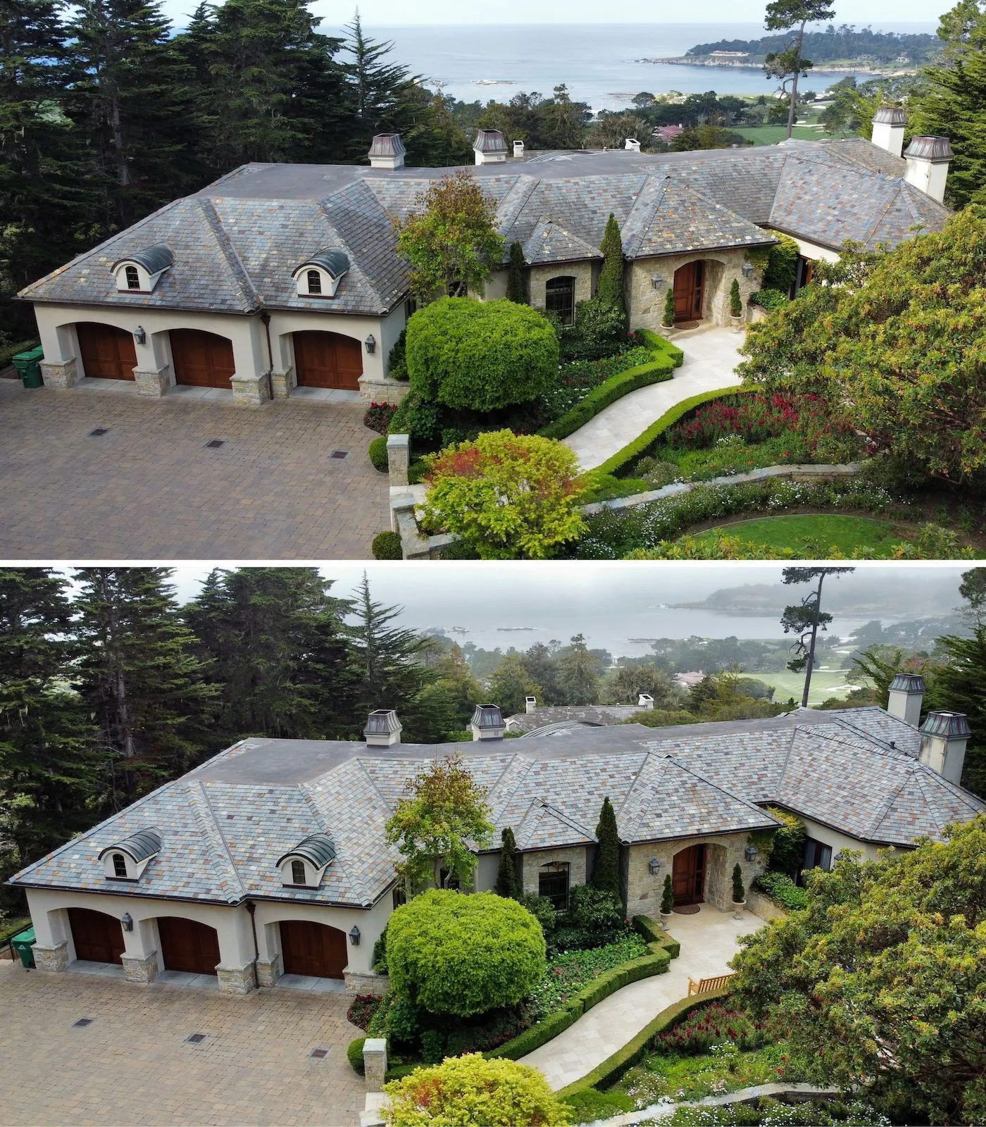 Aerial view of a large stone house with a slate roof, surrounded by lush greenery and an ocean backdrop, featuring a driveway and three wooden garage doors.