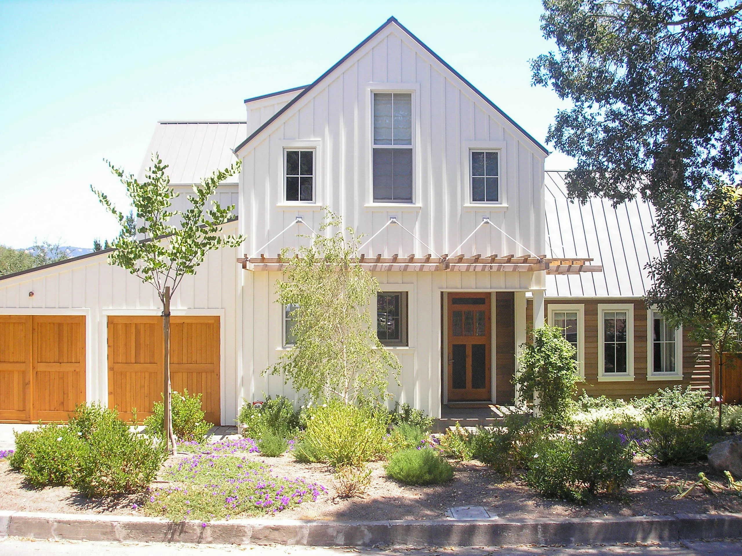 Picture of The pristine white facade of a modern farmhouse is complemented by rich wooden accents, showcasing Sterling Roofing Co., Inc.'s commitment to quality outcomes. This serene setting epitomizes their expertise in roofing design. Copyright ©2025 Diamond Certified Resource

 - Sterling Roofing Co., Inc.