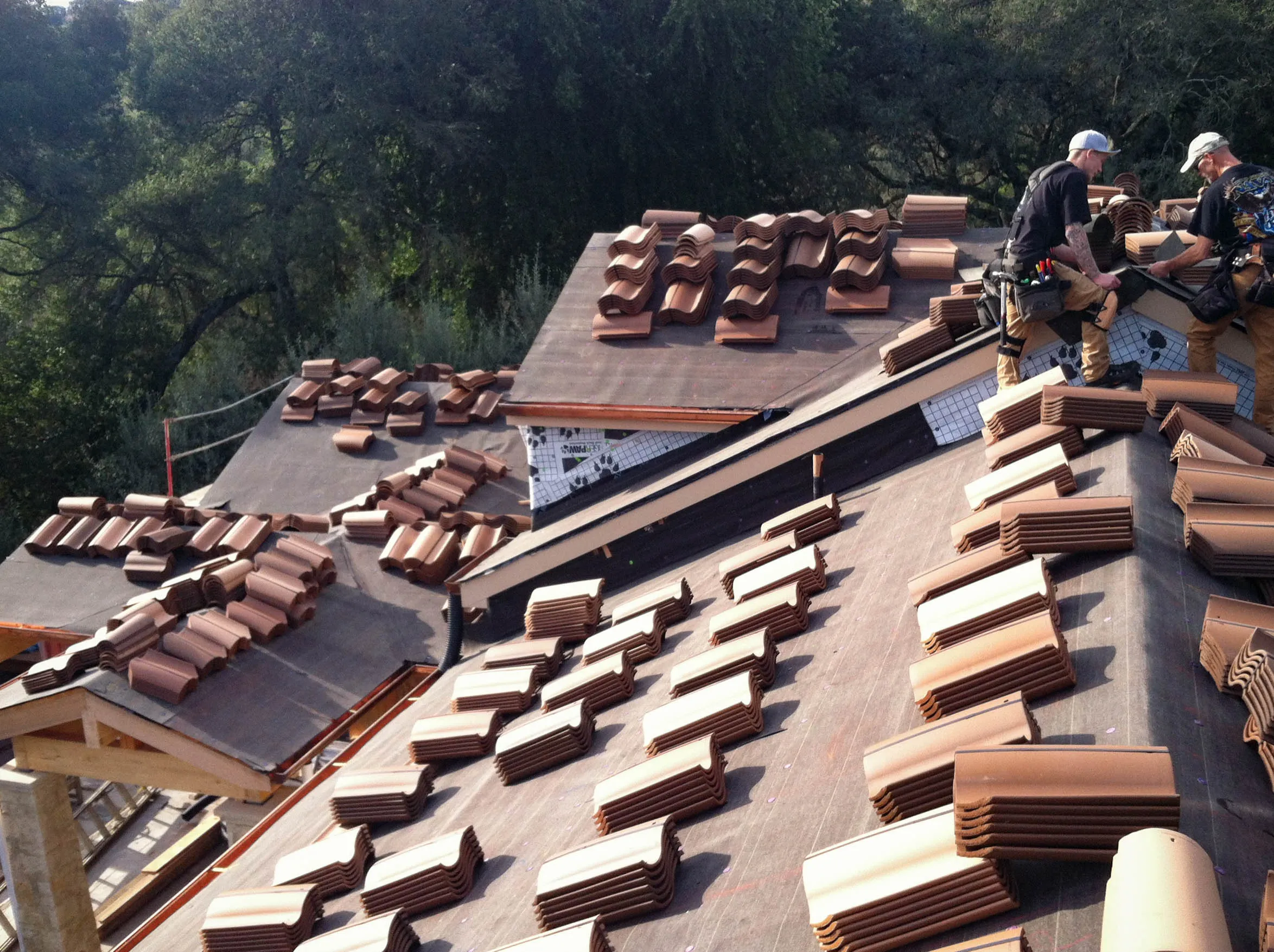 Picture of Sterling Roofing Co., Inc. showcases its commitment to quality during an intricate tile placement on a sunlit roof, embodying its highest quality ratings. Copyright ©2025 Diamond Certified Resource

 - Sterling Roofing Co., Inc.