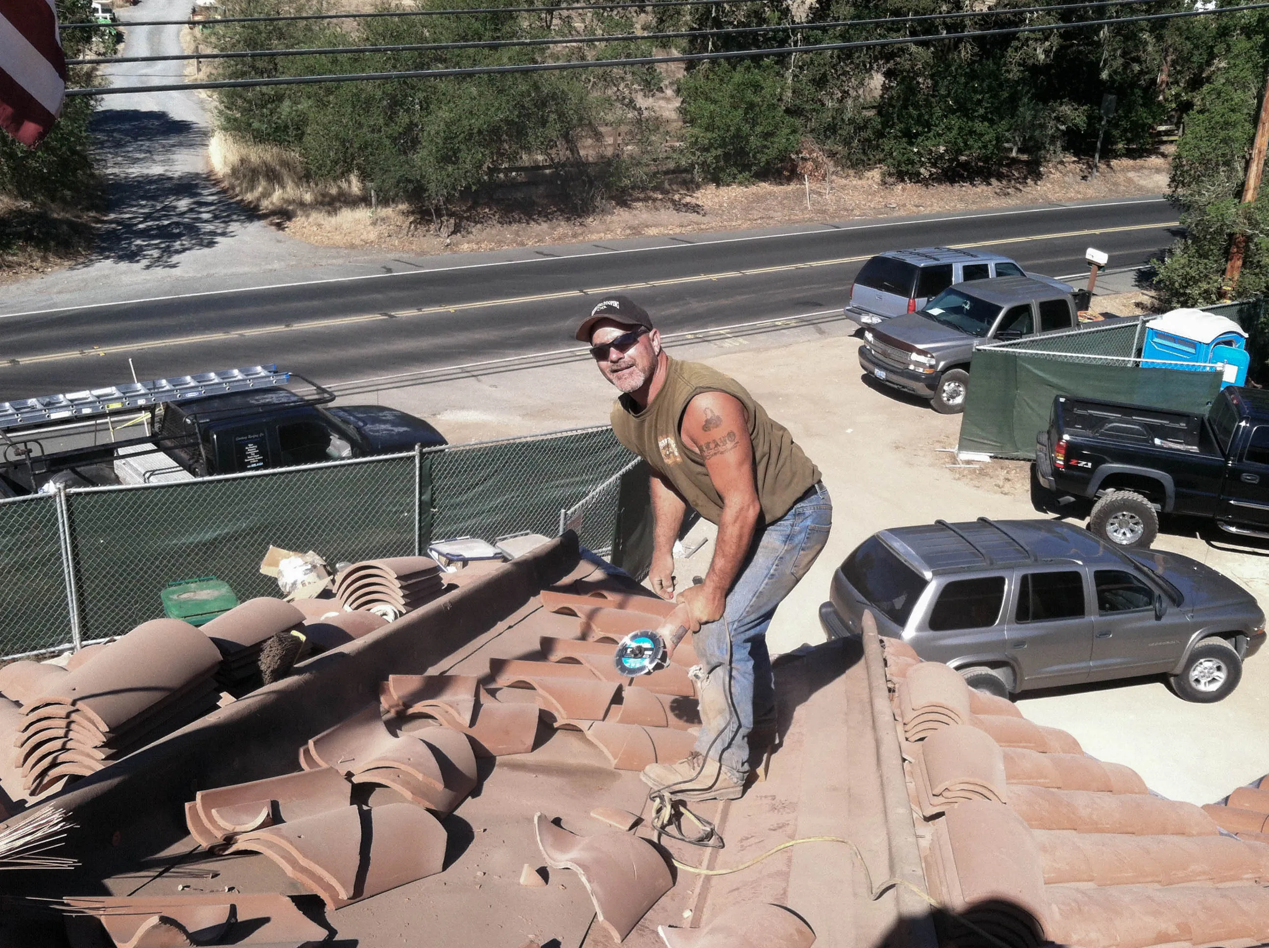 Picture of A skilled worker from Sterling Roofing Co., Inc. pauses during tile installation on a sunlit rooftop, embodying the companyâ€™s focus on quality outcomes recognized for expertise and quality. Copyright ©2025 Diamond Certified Resource

 - Sterling Roofing Co., Inc.