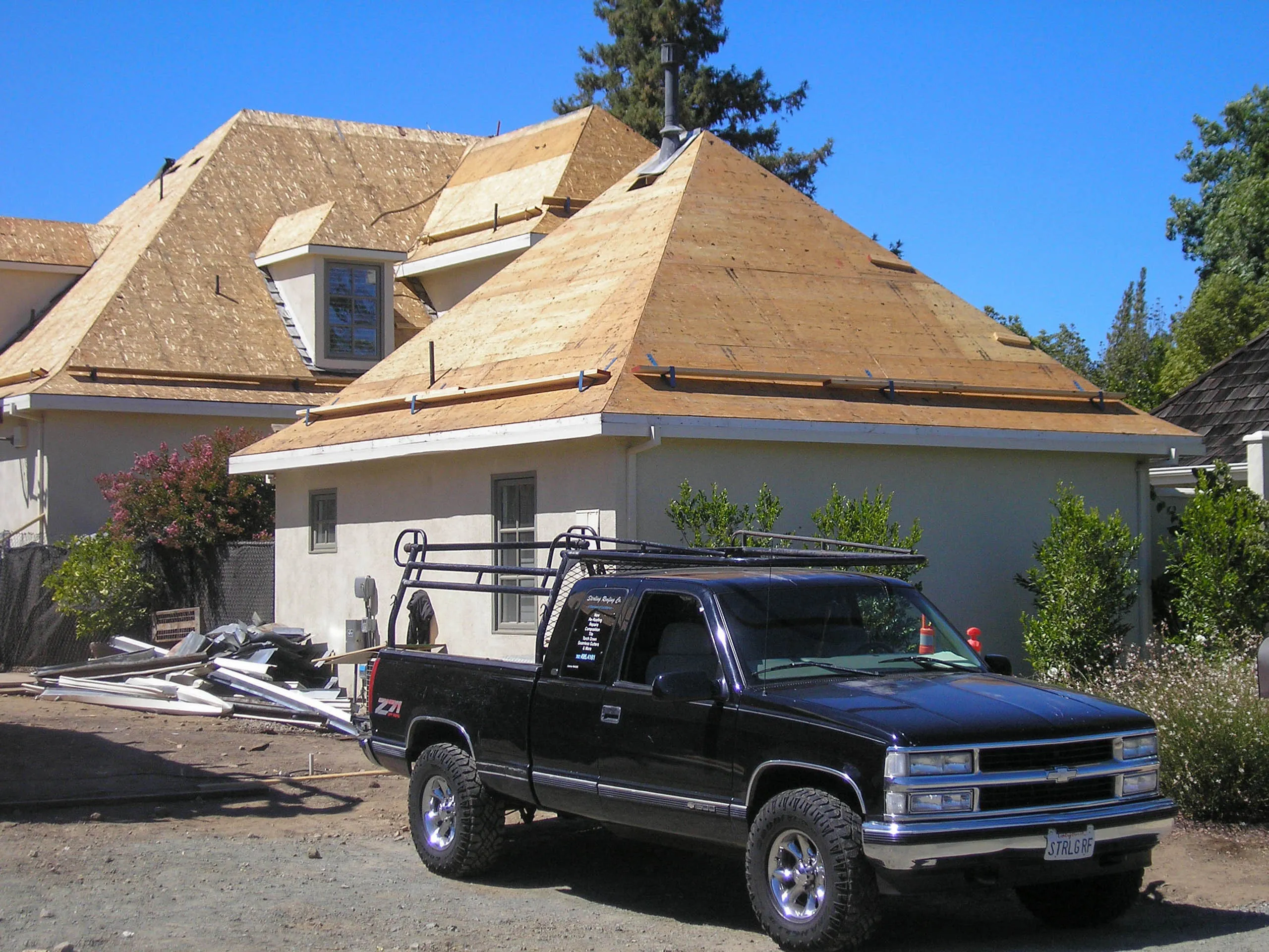 Picture of Under a clear blue sky, Sterling Roofing Co., Inc. transforms this home with new sheathing, showcasing their focus on quality outcomes and attention to detail. Copyright ©2025 Diamond Certified Resource

 - Sterling Roofing Co., Inc.