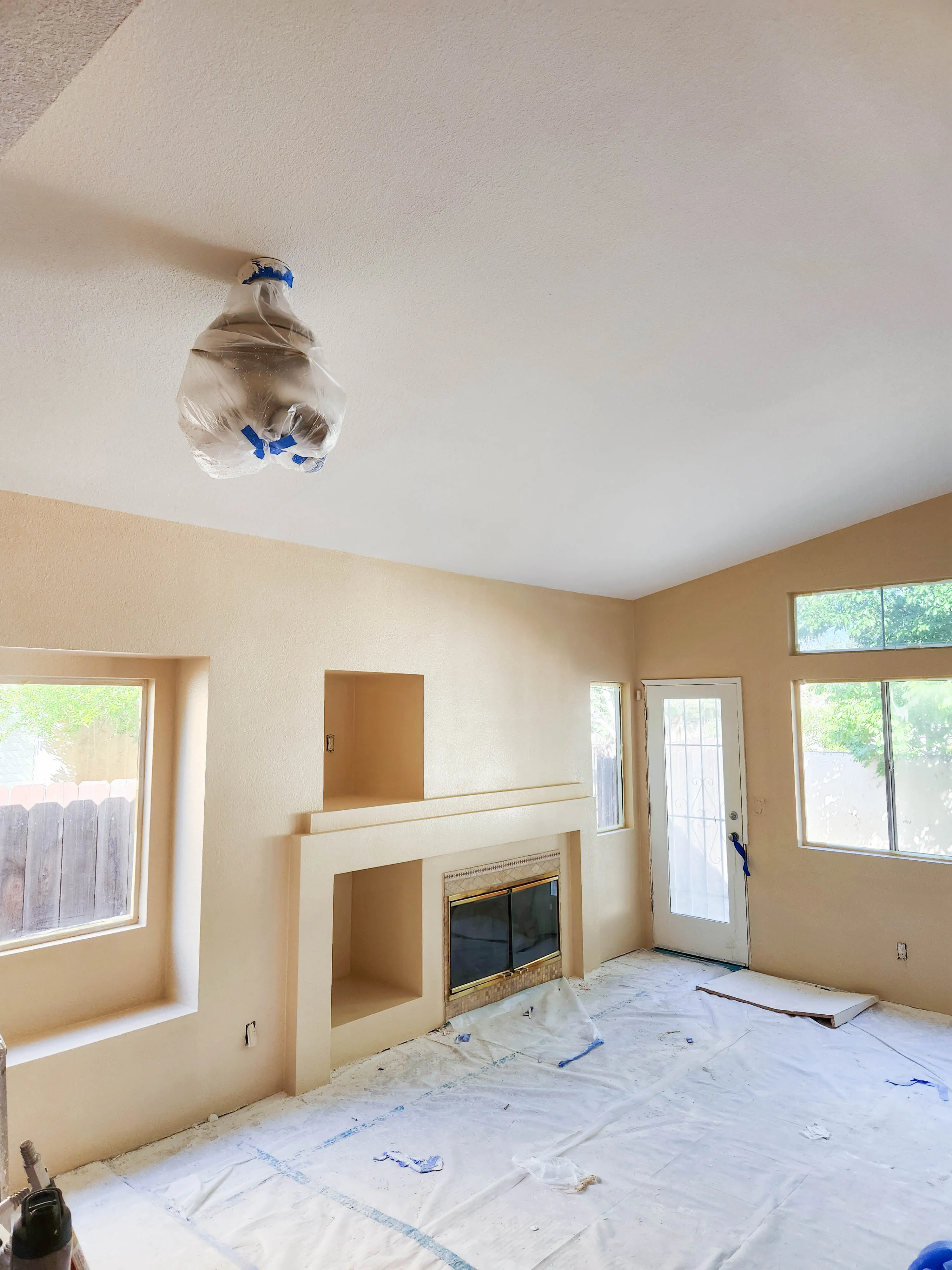 Picture of In a tranquil room prepped for transformation, Sulvaran Drywall showcases their commitment to quality outcomes. The covered light fixture hints at meticulous attention to detail. Sulvaran Drywall focuses on quality outcomes in every project. Copyright ©2025 Diamond Certified Resource - Sulvaran Drywall