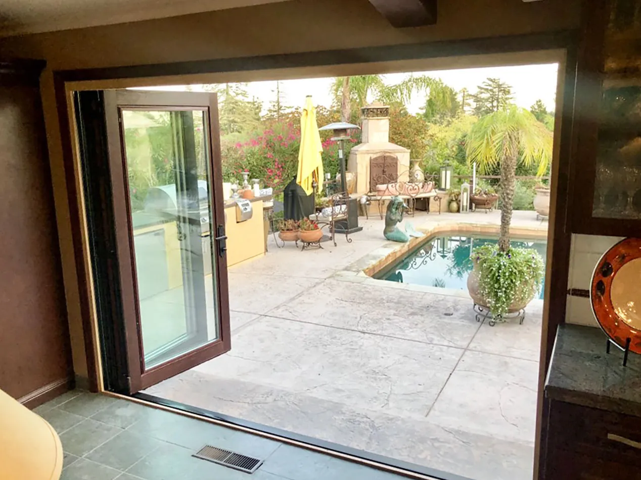 Picture of A newly installed glass door by Abstract Windows seamlessly connects the cozy interior to a lush outdoor oasis, underscoring the companyâ€™s focus on quality outcomes. Copyright ©2025 Diamond Certified Resource

 - Abstract Windows