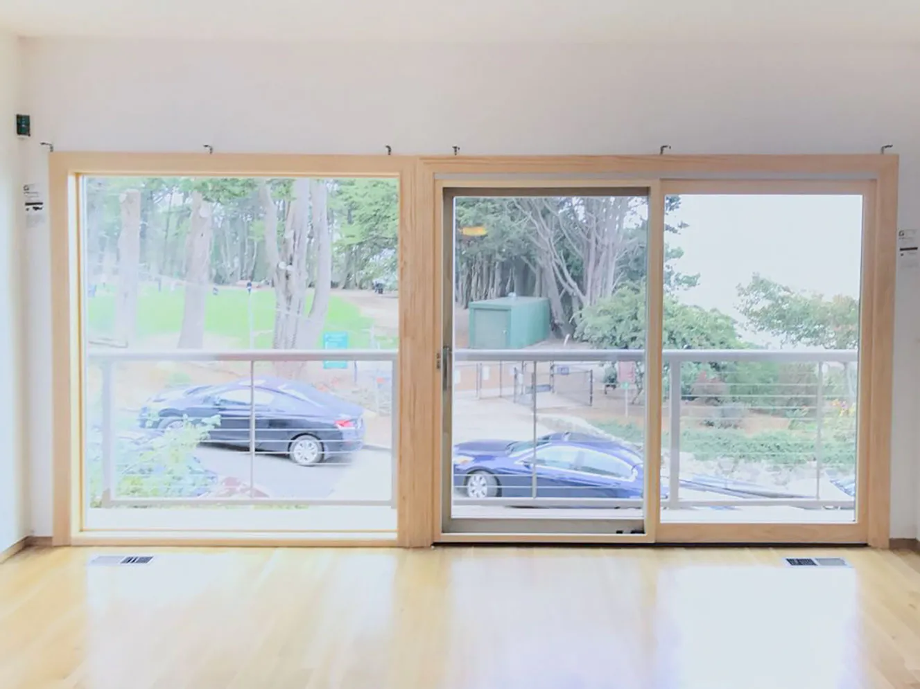 Picture of Sunlight streams through newly installed sliding glass doors, framing a serene view of trees and parked cars. Abstract Windows continues to focus on quality outcomes in every installation. Copyright ©2025 Diamond Certified Resource - Abstract Windows