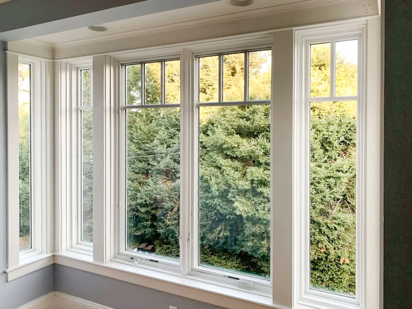 Picture of Light streams through elegant, meticulously installed windows at a peaceful moment of the day, framing a lush view of greenery. Abstract Windows, recognized for expertise and quality, crafts such serene spaces, consistently achieving a Highest in Quality rating. Copyright ©2025 Diamond Certified Resource - Abstract Windows