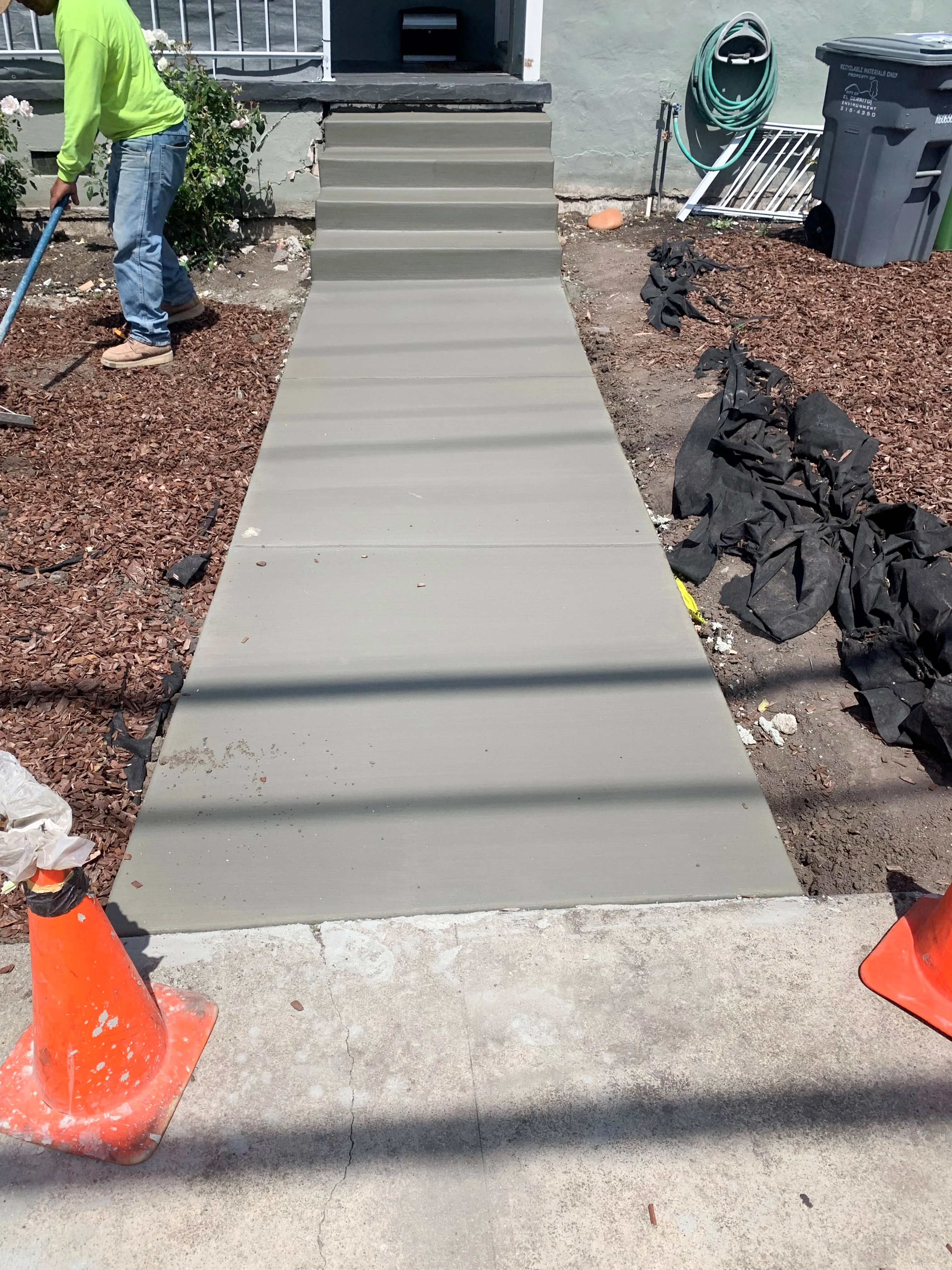 Picture of A worker carefully smooths fresh concrete on a pathway, showcasing ARP Hardscapeâ€™s focus on quality outcomes. With high customer satisfaction ratings, their work transforms spaces with precision. Copyright ©2025 Diamond Certified Resource

 - ARP Hardscape