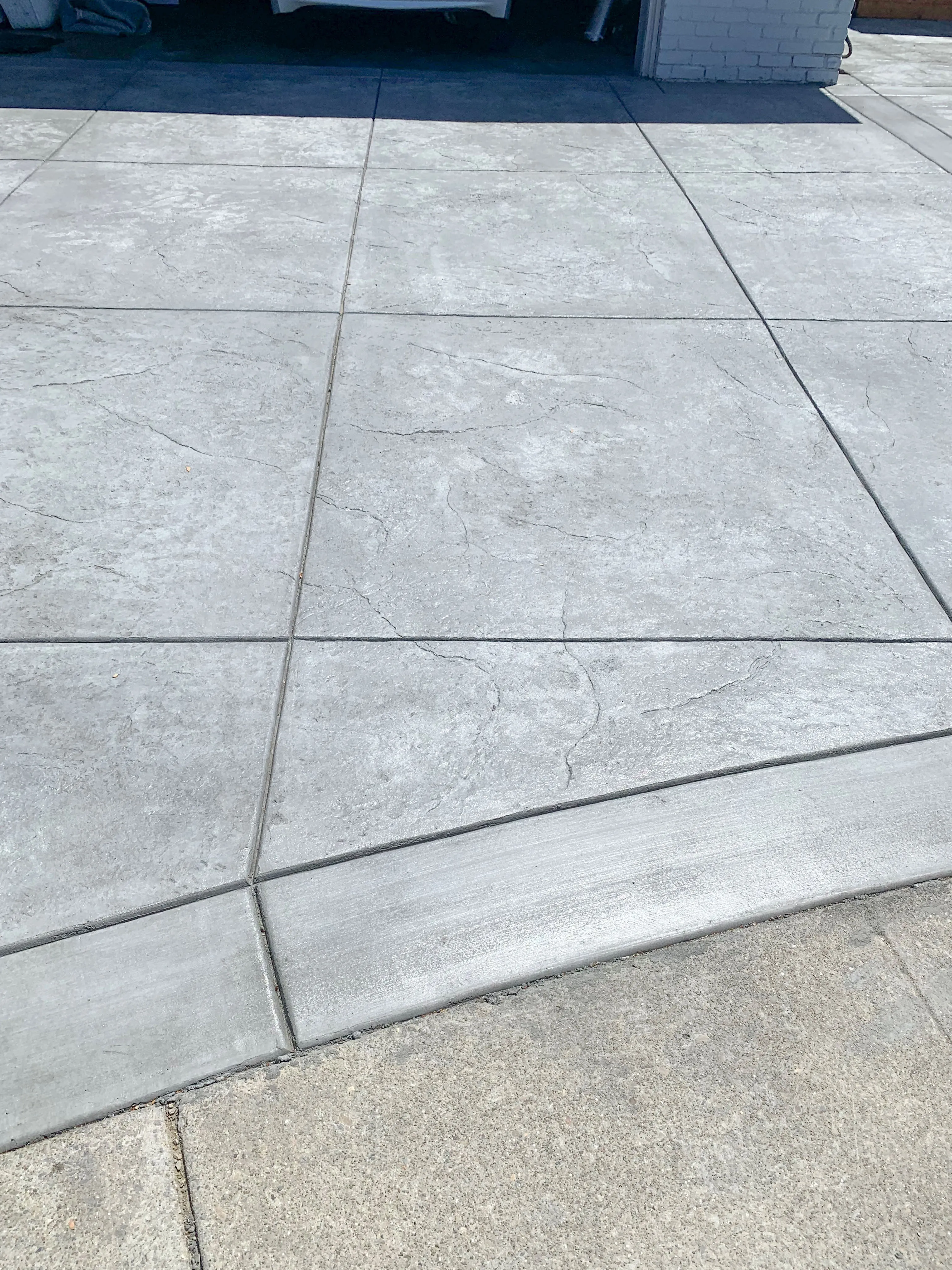 Picture of ARP Hardscape showcases its commitment to quality with this meticulously laid concrete driveway, reflecting their focus on quality outcomes. The precise lines and smooth finish hint at their expertise in creating durable, elegant surfaces. Copyright ©2025 Diamond Certified Resource - ARP Hardscape