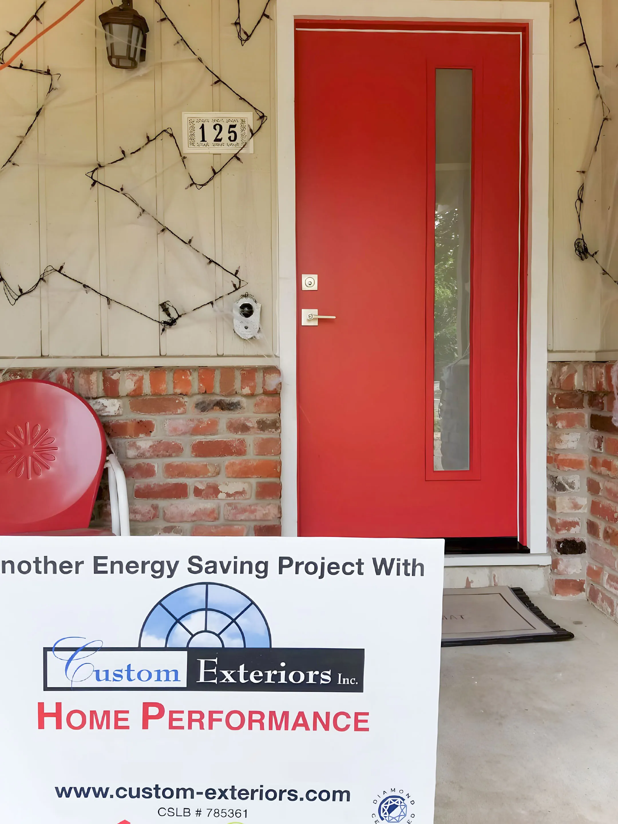 Picture of A vibrant red door stands against a backdrop of neatly arranged bricks and a Custom Exteriors, Inc. sign, highlighting their commitment to home energy efficiency. Recognized for expertise and quality, Custom Exteriors, Inc. continues to deliver high customer satisfaction. Copyright ©2025 Diamond Certified Resource

 - Custom Exteriors, Inc.