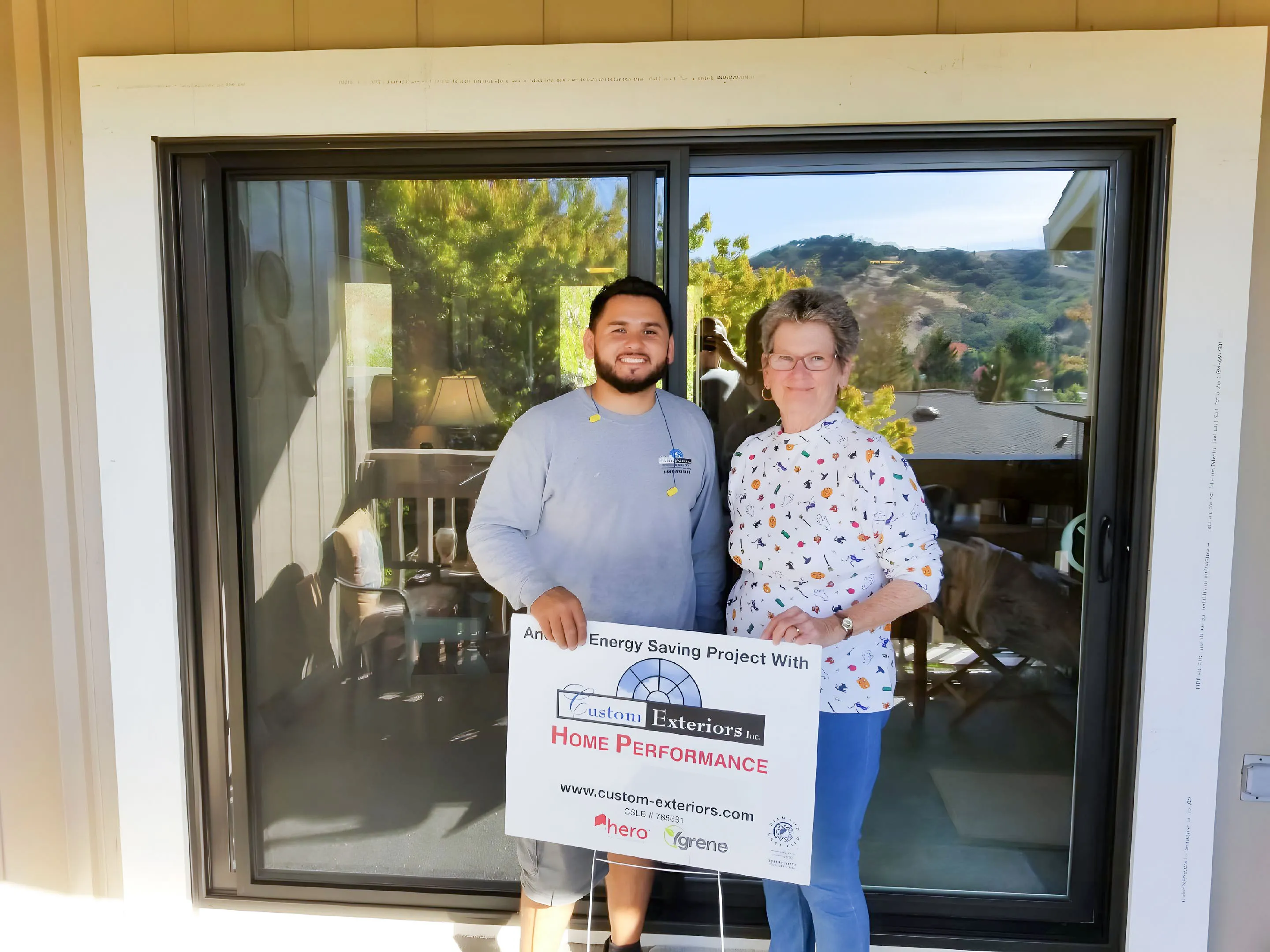 Picture of Standing proudly with a satisfied customer, a Custom Exteriors, Inc. professional holds a sign highlighting an energy-saving project. This moment underscores the company's focus on quality outcomes. Copyright ©2025 Diamond Certified Resource

 - Custom Exteriors, Inc.