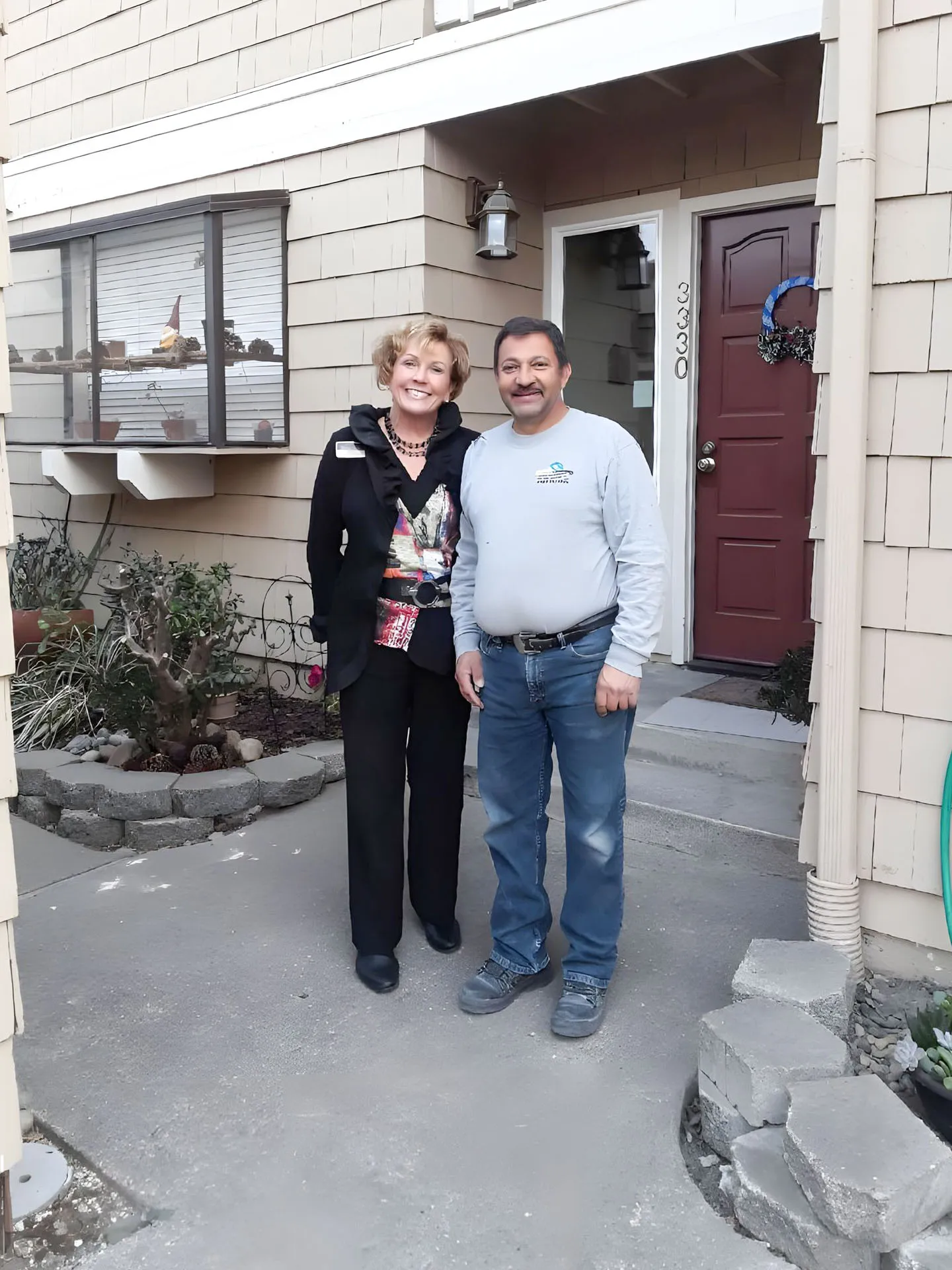 Picture of Standing proudly in front of a recently completed exterior renovation, a Custom Exteriors, Inc. team member shares a moment with a satisfied client, exemplifying the companyâ€™s focus on quality outcomes. Copyright ©2025 Diamond Certified Resource

 - Custom Exteriors, Inc.