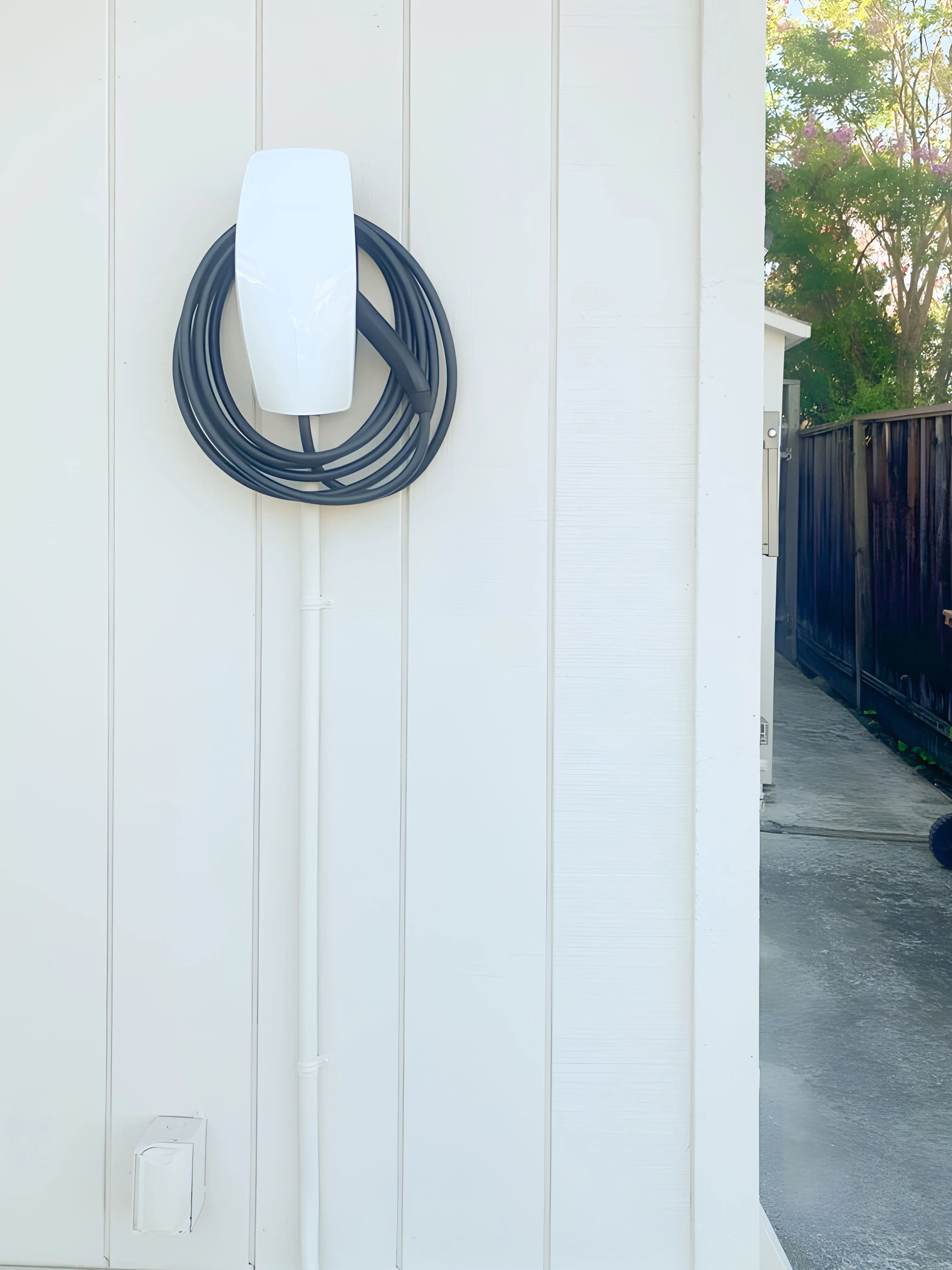 Picture of A neatly installed electric vehicle charger on a pristine wall hints at a commitment to sustainability. Frontline Electrical Services, recognized for expertise and quality, ensures every installation is seamless and efficient. Copyright ©2025 Diamond Certified Resource - Frontline Electrical Services