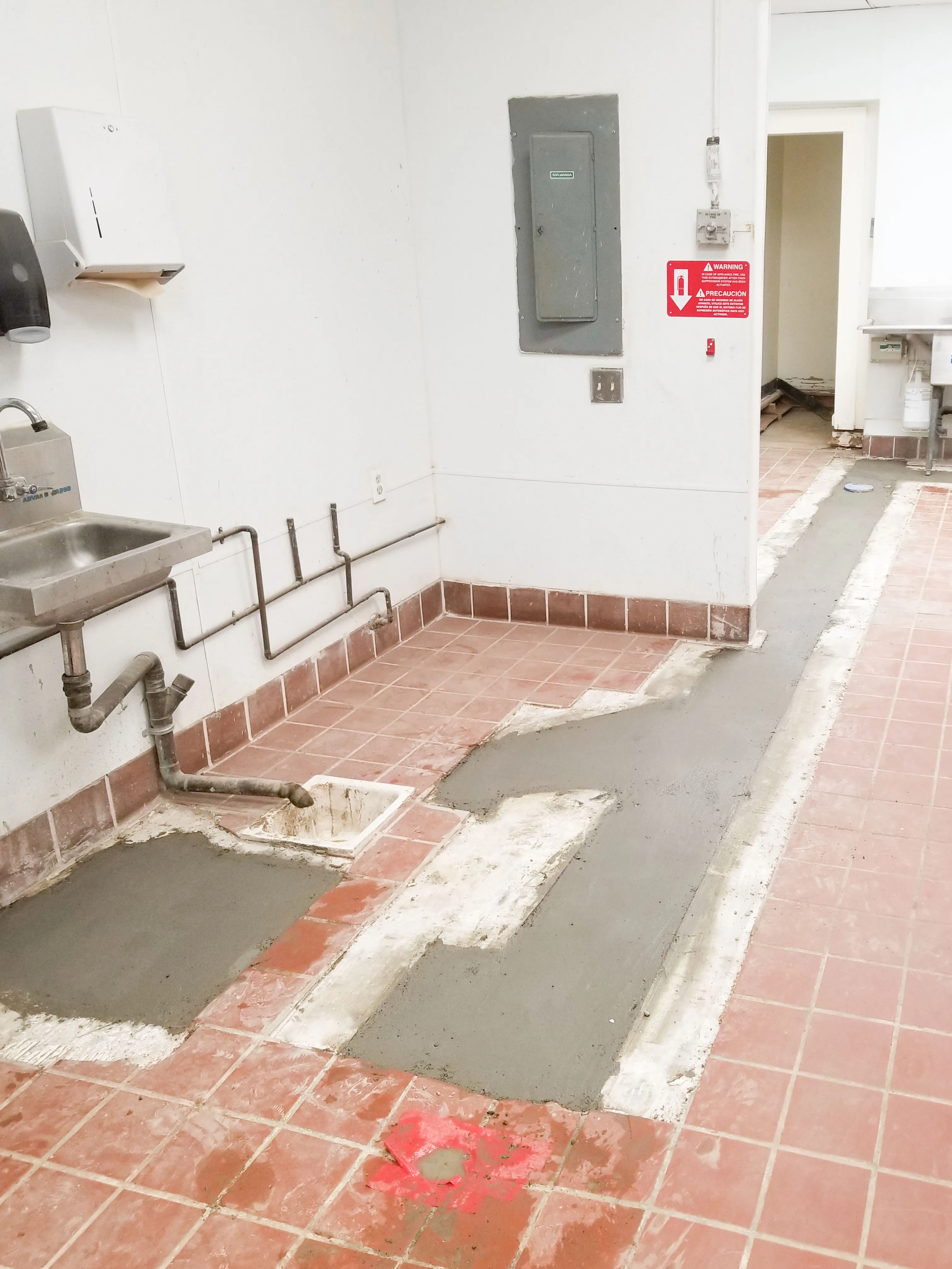 Picture of In a subtle yet significant transformation, freshly laid concrete patches renovate a tiled floor, hinting at meticulous plumbing work by Gray Plumbing Inc. The company consistently achieves a Highest in Quality rating, ensuring long-lasting results. Copyright ©2025 Diamond Certified Resource

 - Gray Plumbing Inc