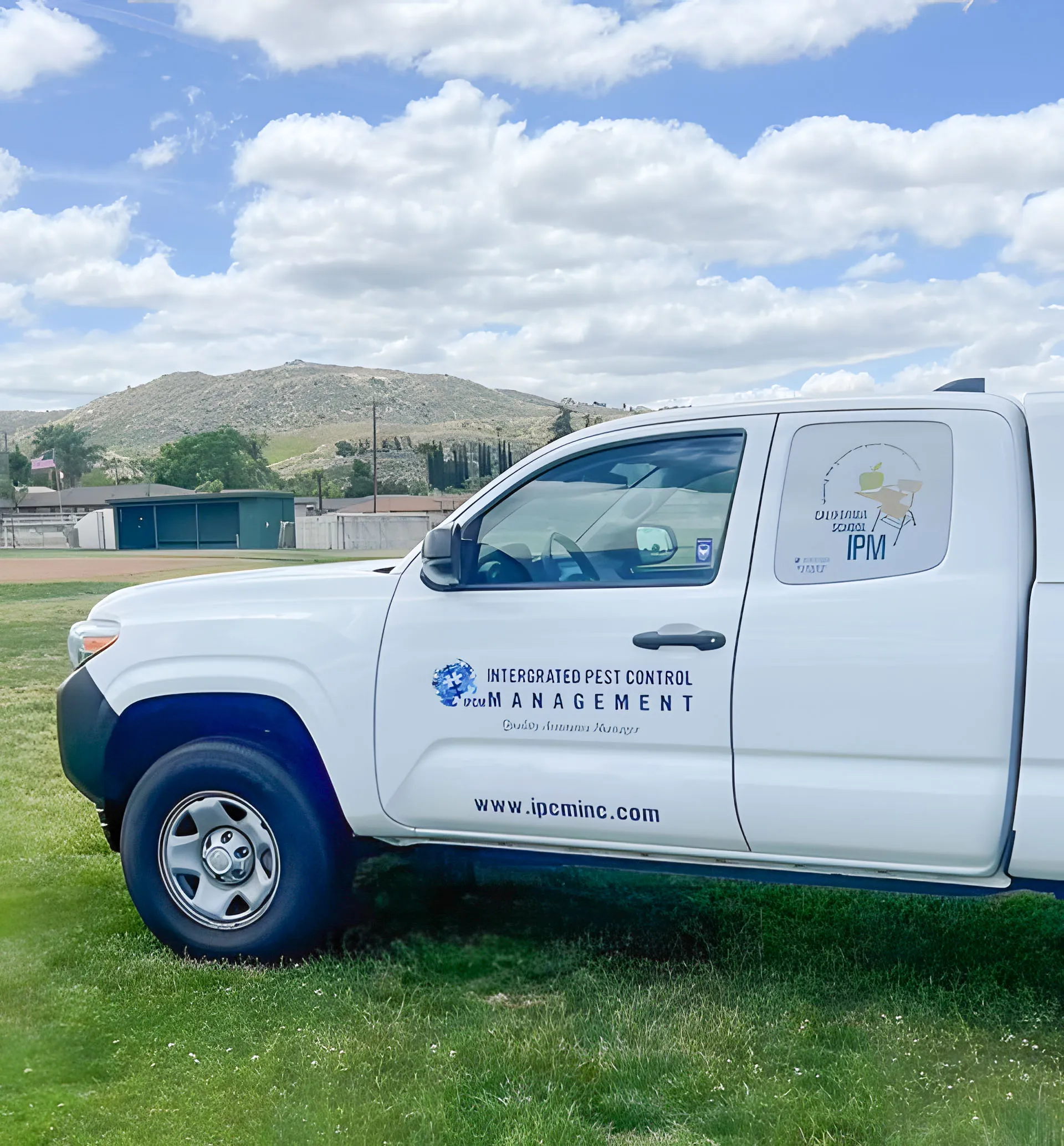 Picture of A sleek Intergrated Pest Control Management Inc. truck is parked beside a lush field, hinting at a routine inspection. The environment reflects the company's focus on quality outcomes. Copyright ©2025 Diamond Certified Resource

 - Intergrated Pest Control Management Inc.