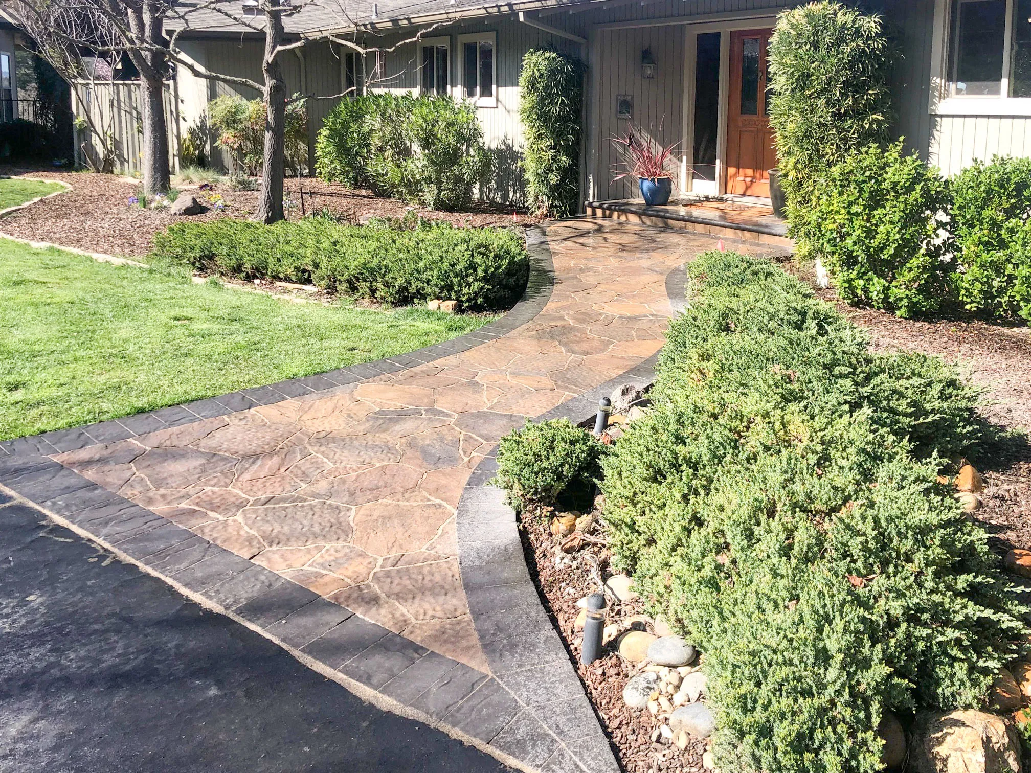 Picture of A beautifully crafted stone pathway leads to the entrance of a home, showcasing the meticulous attention to design by Mr. Pavers Contractor Services, Inc. Known for focusing on quality outcomes, the company highlights how a well-laid path can enhance curb appeal and invite warmth. Copyright ©2025 Diamond Certified Resource

 - Mr. Pavers Contractor Services, Inc.