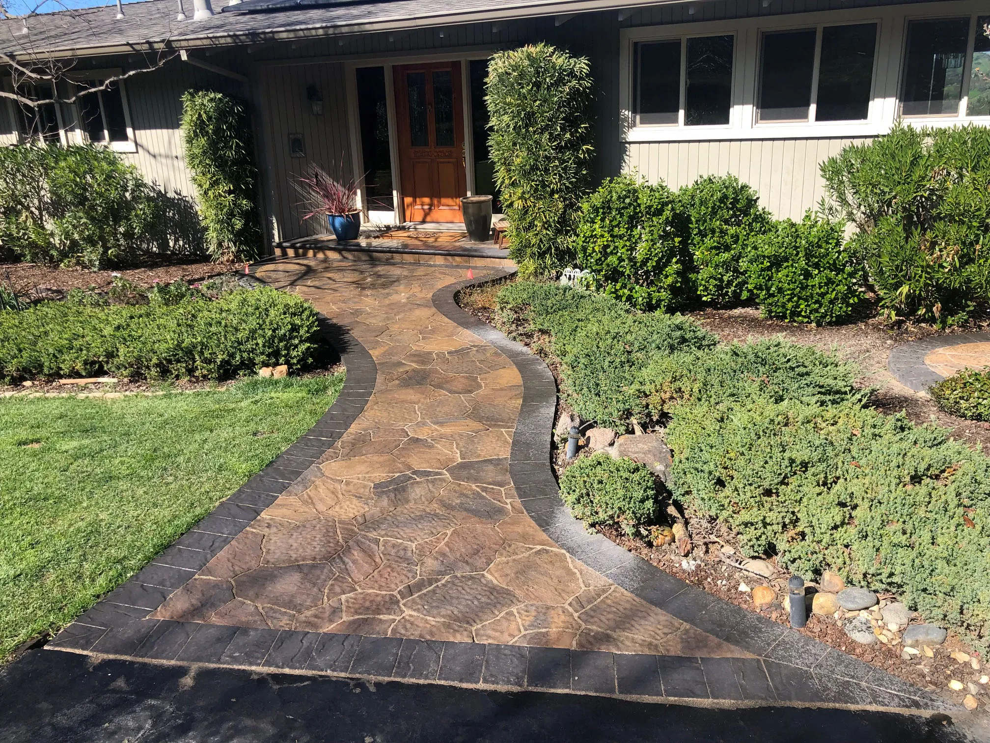 Picture of A meticulously crafted stone walkway leads to a welcoming entrance, embodying the quality outcomes Mr. Pavers Contractor Services, Inc. is renowned for. This serene landscape demonstrates their commitment to detail and excellence, consistently achieving a Highest in Quality rating. Copyright ©2025 Diamond Certified Resource

 - Mr. Pavers Contractor Services, Inc.