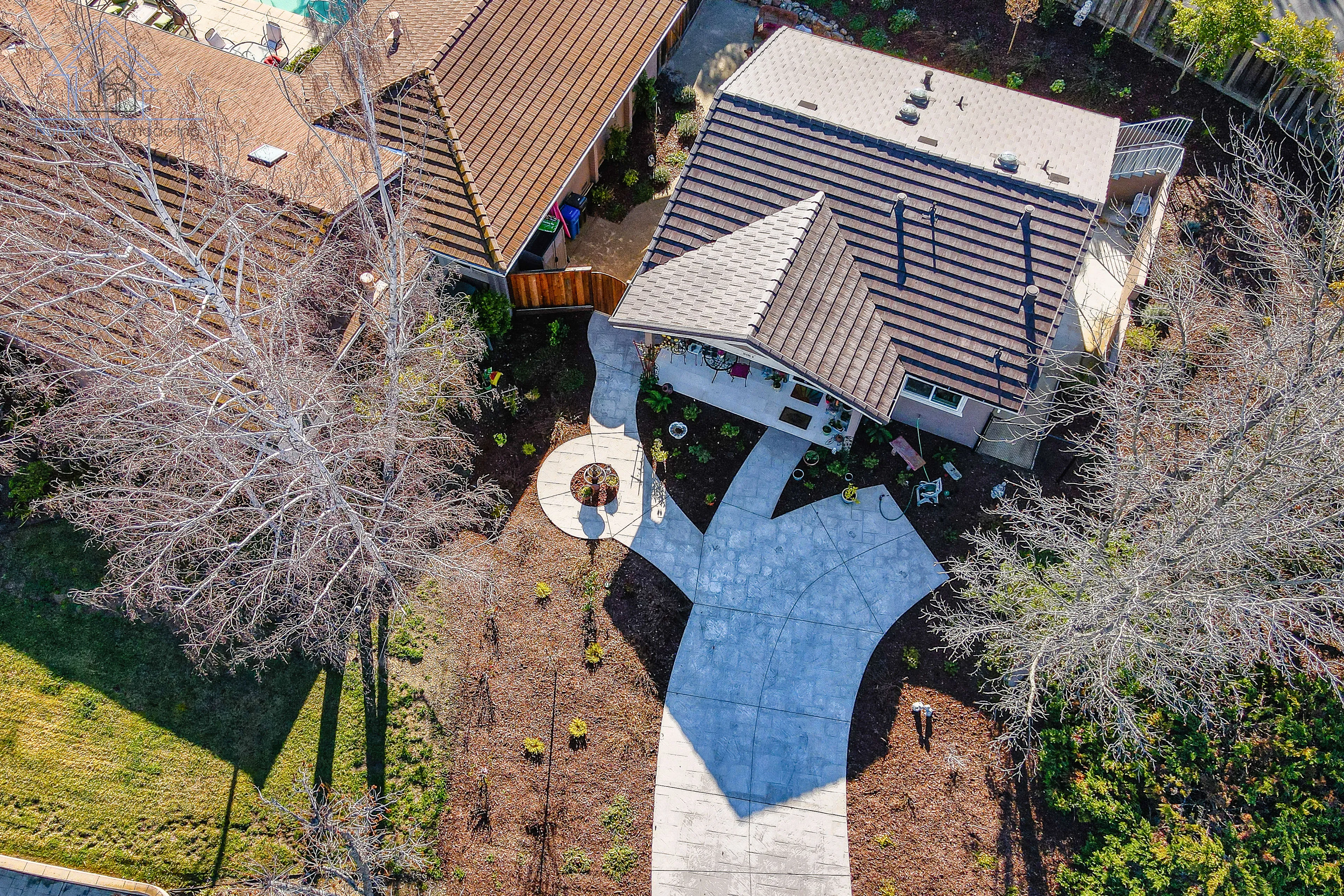 Picture of A stunning aerial view captures the intricate design of a newly remodeled backyard by NuHome Remodeling, showcasing their commitment to quality outcomes through expert craftsmanship. With an artfully constructed pathway leading to a cozy patio, this project highlights why the company is top rated for Quality. Copyright ©2025 Diamond Certified Resource

 - NuHome Remodeling