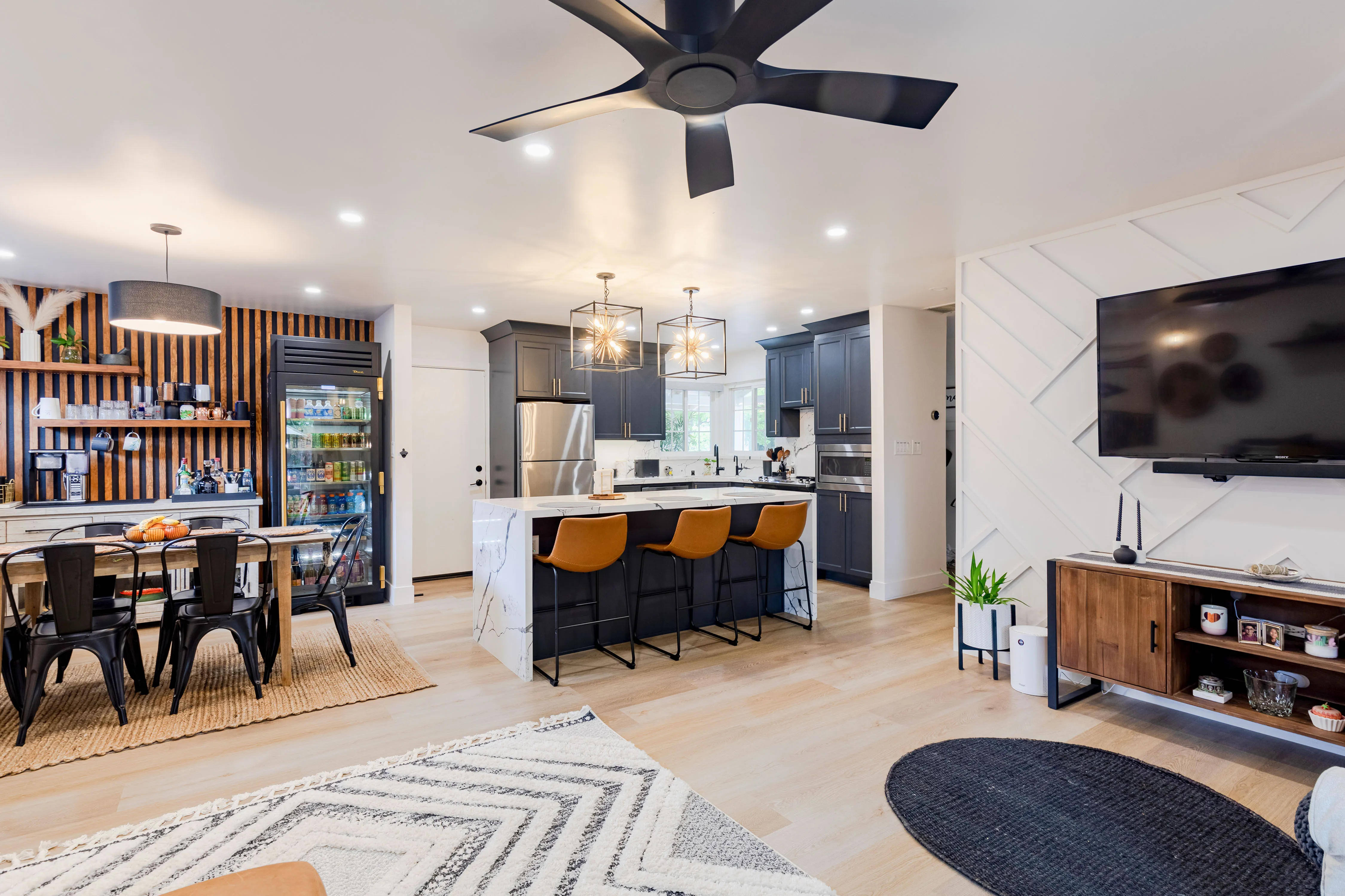 Picture of In this modern open-concept kitchen and living area, NuHome Remodeling showcases its commitment to quality outcomes with sleek cabinetry and a spacious island. The harmonious design reflects the company's recognition for expertise and quality. Copyright ©2025 Diamond Certified Resource - NuHome Remodeling