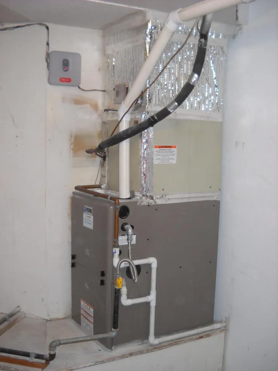 Picture of In a quiet corner, a newly installed heating unit stands resilient, embodying Qualtech Heating & Cooling's commitment to quality outcomes. This installation reflects the companyâ€™s focus on quality service. Copyright ©2025 Diamond Certified Resource - Qualtech Heating & Cooling