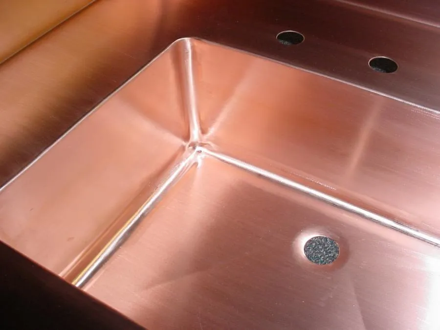 Picture of The lustrous finish of a meticulously crafted copper sink exemplifies Bell Products, Inc.'s dedication to quality outcomes. This piece reflects their top-rated craftsmanship. Copyright ©2025 Diamond Certified Resource. - Bell Products, Inc.