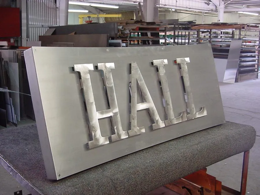 Picture of In the heart of the workshop, Bell Products, Inc. showcases craftsmanship and precision with this "HALL" sign, symbolizing their commitment to quality. The company's focus on quality outcomes ensures each piece is a testament to excellence. Copyright ©2025 Diamond Certified Resource. - Bell Products, Inc.