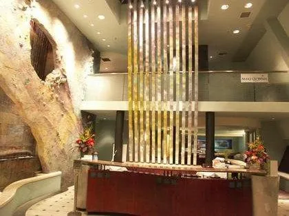 Picture of In the heart of Prime Time Athletic Club, a sleek reception area sets the tone with a modern waterfall feature cascading against a rock wall. Known for its focus on quality outcomes, the club combines striking design with top-tier services. Copyright ©2025 Diamond Certified Resource - Prime Time Athletic Club