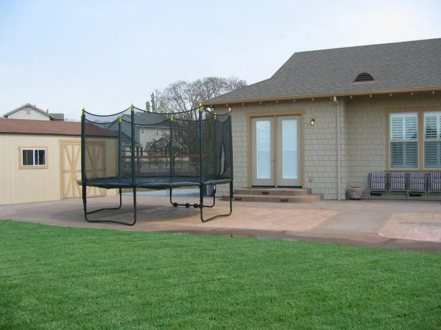 Picture of  A well-crafted backyard patio features a securely enclosed trampoline, exemplifying Gold Hammer Construction, Inc.'s focus on quality outcomes. The space invites leisure while ensuring safety. Copyright ©2025 Diamond Certified Resource.

 - Gold Hammer Construction, Inc.