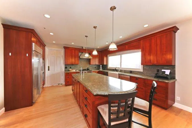 Picture of  In this beautifully remodeled kitchen by Gold Hammer Construction, Inc., the elegant granite countertops and rich wooden cabinetry speak volumes of the company’s focus on quality outcomes. Copyright ©2025 Diamond Certified Resource.

 - Gold Hammer Construction, Inc.