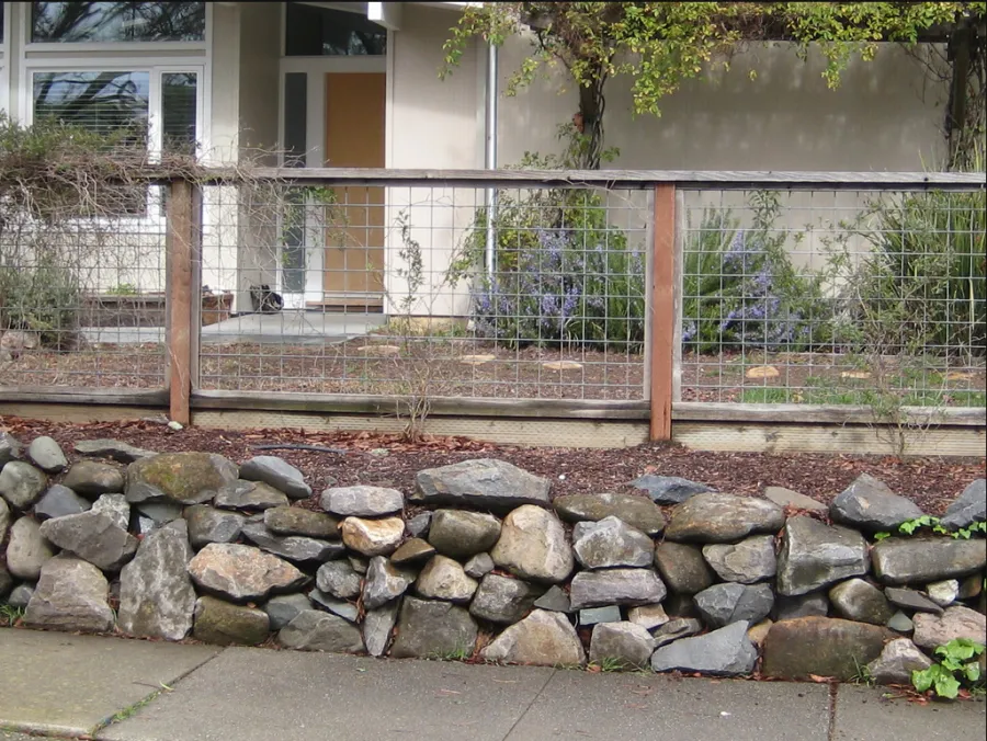 Picture of A meticulously crafted fence by California Fencing blends metal and wood, evoking a sense of rustic elegance while ensuring security. The company focuses on quality outcomes, as seen in the seamless integration with the natural setting. Copyright ©2025 Diamond Certified Resource

 - California Fencing