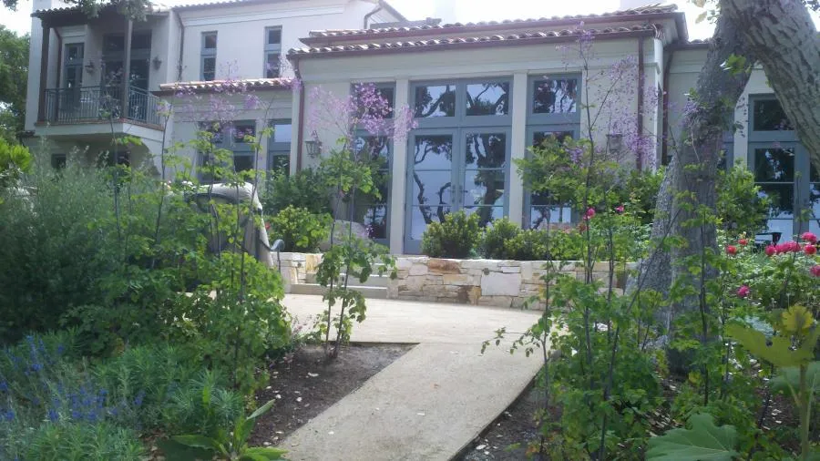 Picture of  Amidst a lush garden, a serene pathway leads to a picturesque home facade enhanced by Jerry Allison Landscaping, Inc., known for consistently achieving a Highest in Quality rating. Copyright ©2025 Diamond Certified Resource.

 - Jerry Allison Landscaping, Inc.