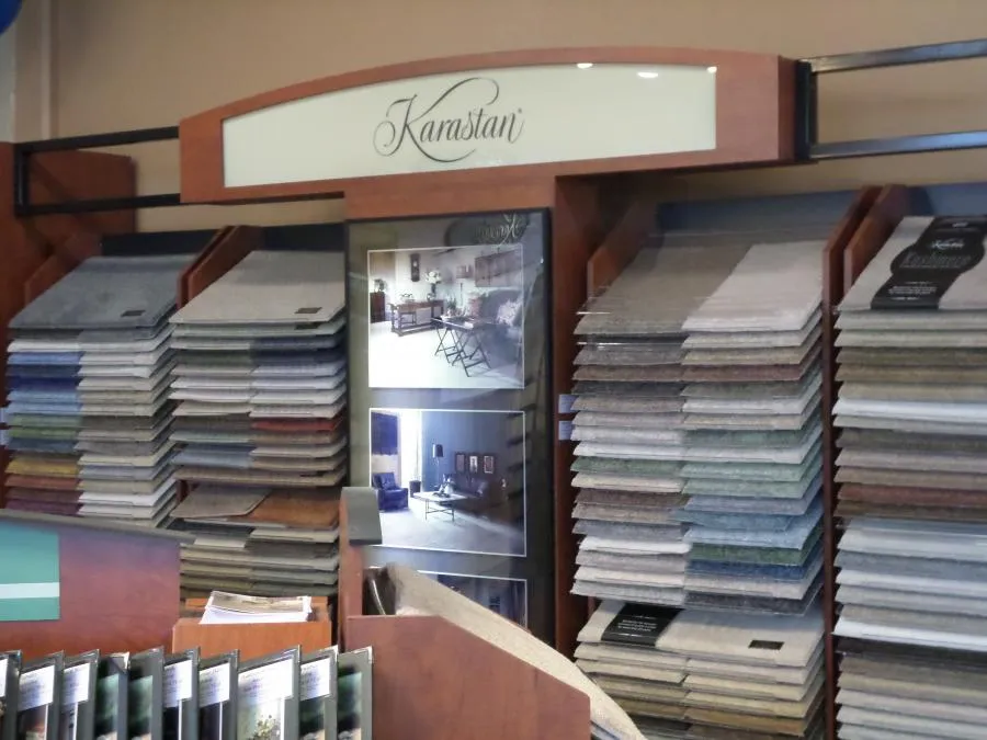 Picture of A meticulously organized display of carpet samples at The Floor Store invites customers to explore a spectrum of textures and colors. Known for high customer satisfaction ratings, the company ensures quality outcomes with every selection. Copyright ©2025 Diamond Certified Resource - The Floor Store
