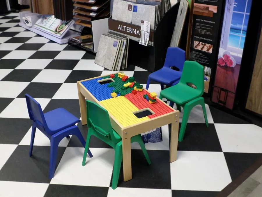 Picture of A small play area with colorful chairs and a Lego tableâ€”a thoughtful touch at The Floor Store. Here, quality extends beyond flooring, reflecting the top-rated customer satisfaction they've earned. Copyright ©2025 Diamond Certified Resource

 - The Floor Store