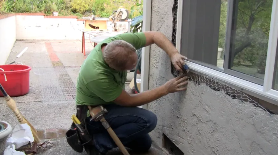 Picture of A skilled professional from Alexander Company carefully installs mesh alongside a window, ensuring precision in their craft. This attention to detail reflects the company's consistent achievement in quality ratings. Copyright ©2025 Diamond Certified Resource - Alexander Company
