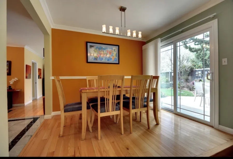 Picture of In a sunlit dining area, the vibrant orange wall echoes the quality craftsmanship of Sigura Pro Painting, enhancing the home's warmth and style. The company is recognized for expertise and quality, ensuring satisfaction. Copyright ©2025 Diamond Certified Resource

 - Sigura Pro Painting