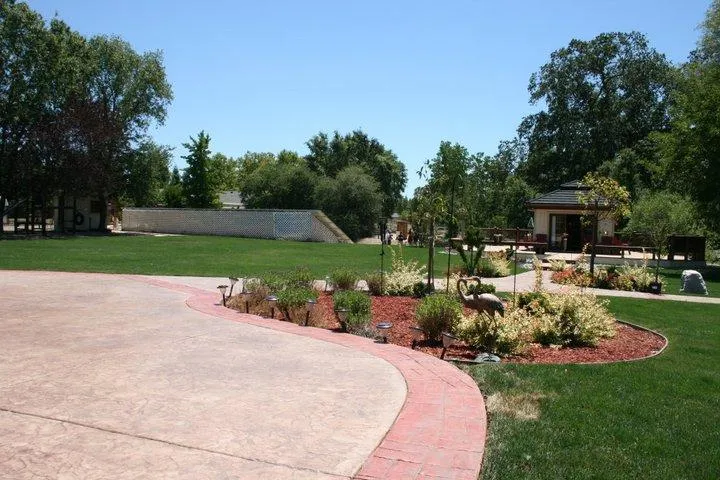 Picture of Nestled amidst a vibrant landscape, the precise curvature of the pathway at this home reflects the commitment to quality outcomes by Quality First Home Improvement, Inc. Recognized for expertise and quality, the company’s touch is evident in the meticulous design. Copyright ©2025 Diamond Certified Resource. - Quality First Home Improvement, Inc.