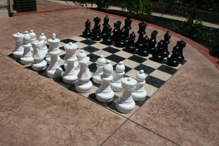 Picture of A life-sized chess set rests on a custom-constructed outdoor board, blending recreation with craftsmanship. Quality First Home Improvement, Inc. showcases its focus on quality outcomes, merging leisure with precision. Copyright ©2025 Diamond Certified Resource. - Quality First Home Improvement, Inc.