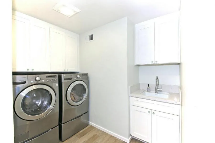 Picture of In this pristine laundry room, sleek appliances complement the crisp, white cabinetry. Gold Hammer Construction, Inc. delivers spaces marked by quality outcomes, ensuring high customer satisfaction. Copyright ©2025 Diamond Certified Resource. - Gold Hammer Construction, Inc.