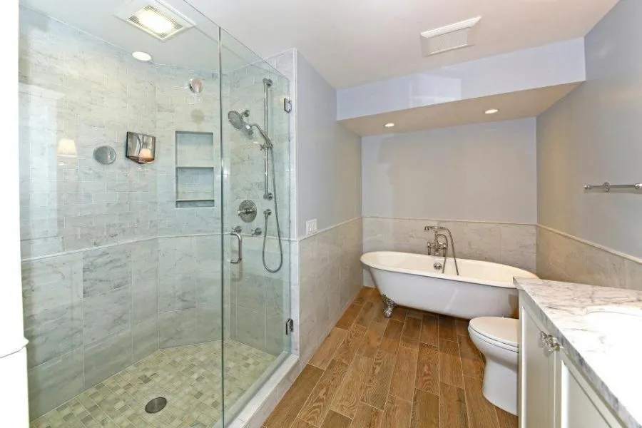 Picture of  A pristine bathroom showcases Gold Hammer Construction, Inc.'s commitment to quality outcomes, featuring a glass-enclosed shower and elegant clawfoot tub. The company's expertise is recognized for its high customer satisfaction ratings. Copyright ©2025 Diamond Certified Resource.

 - Gold Hammer Construction, Inc.