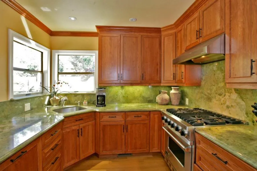 Picture of  In a blend of warm wood tones and vibrant green stonework, Gold Hammer Construction, Inc. showcases a sophisticated kitchen design. Their focus on quality outcomes is evident in every detail. Copyright ©2025 Diamond Certified Resource.

 - Gold Hammer Construction, Inc.